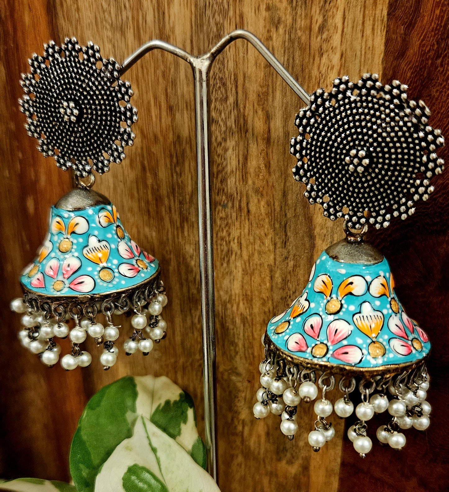 Silver finish jhumka with hand painted dome under a circular stud