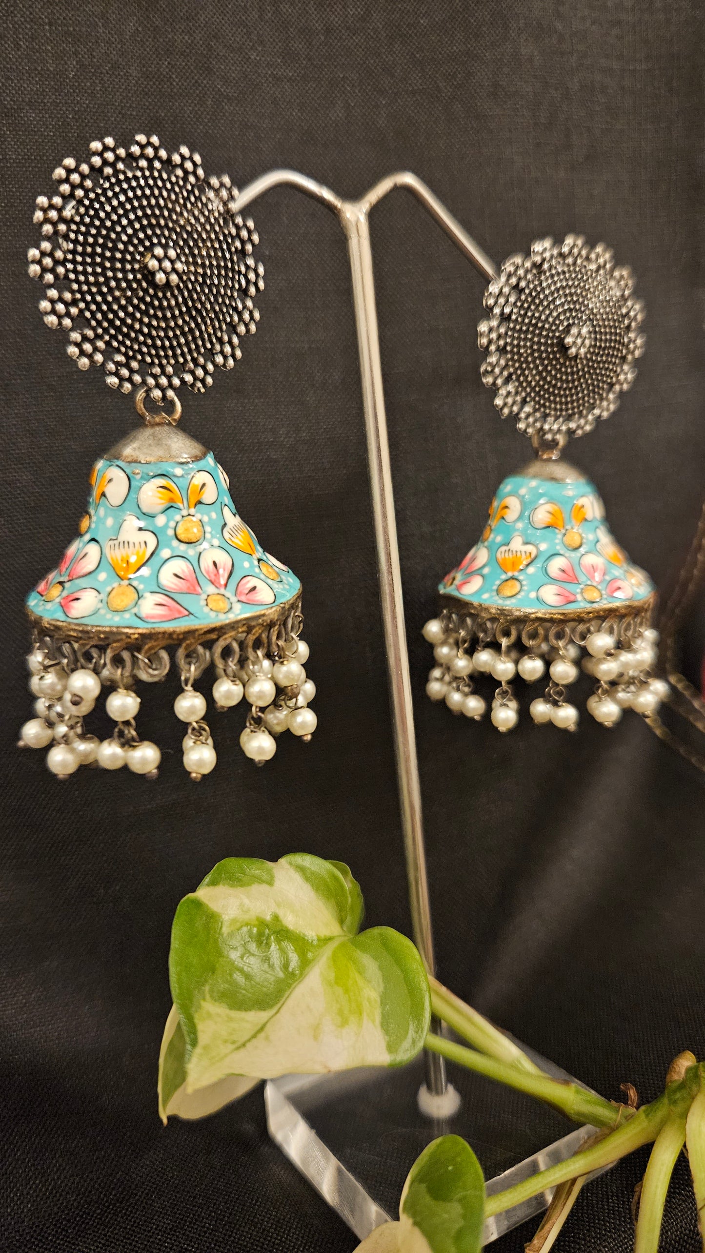 Silver finish jhumka with hand painted dome under a circular stud