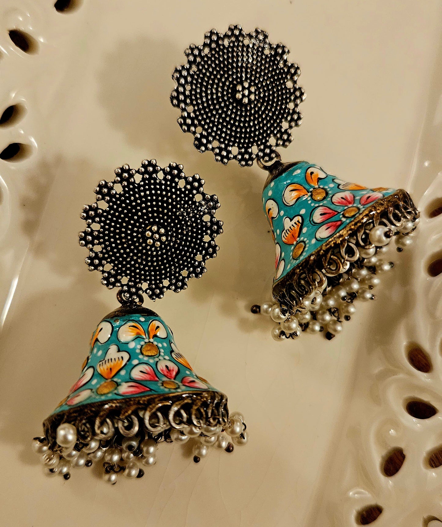 Silver finish jhumka with hand painted dome under a circular stud