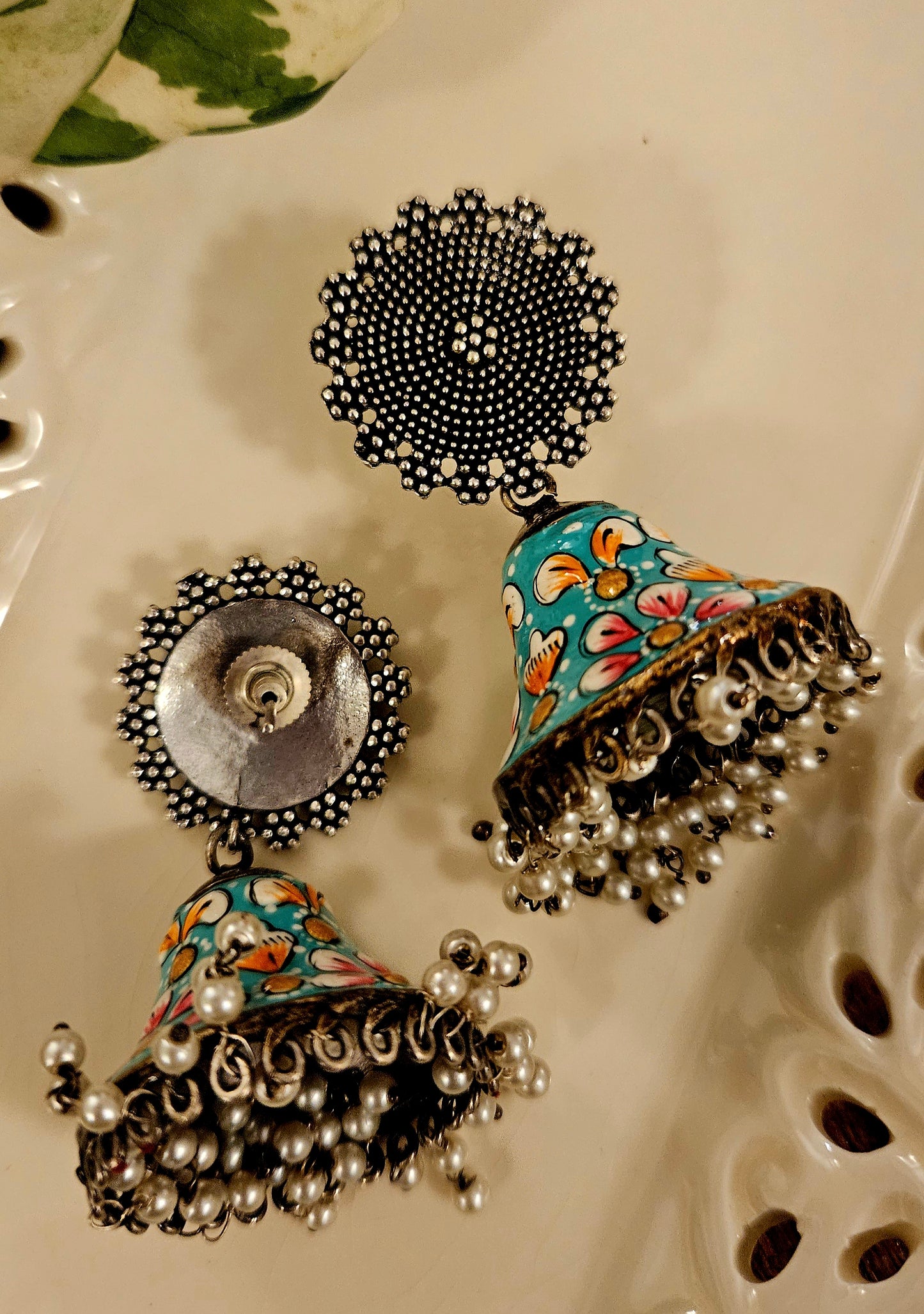 Silver finish jhumka with hand painted dome under a circular stud