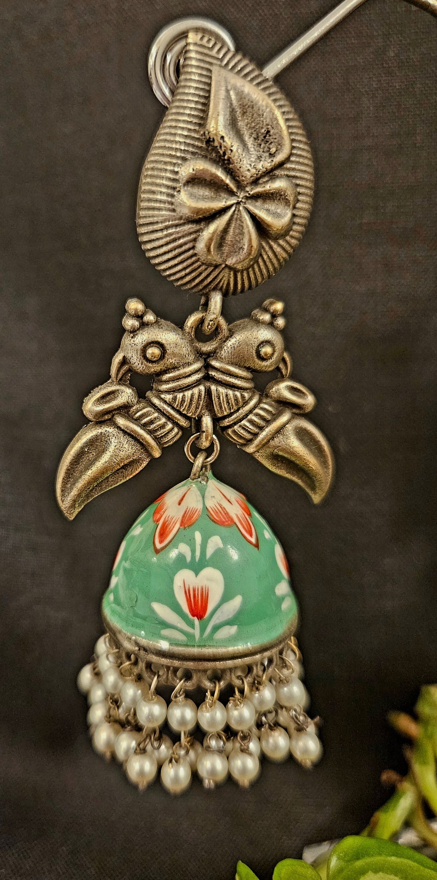 Silver finish hand painted jhumka (earrings) with paisley stud and parrot motif