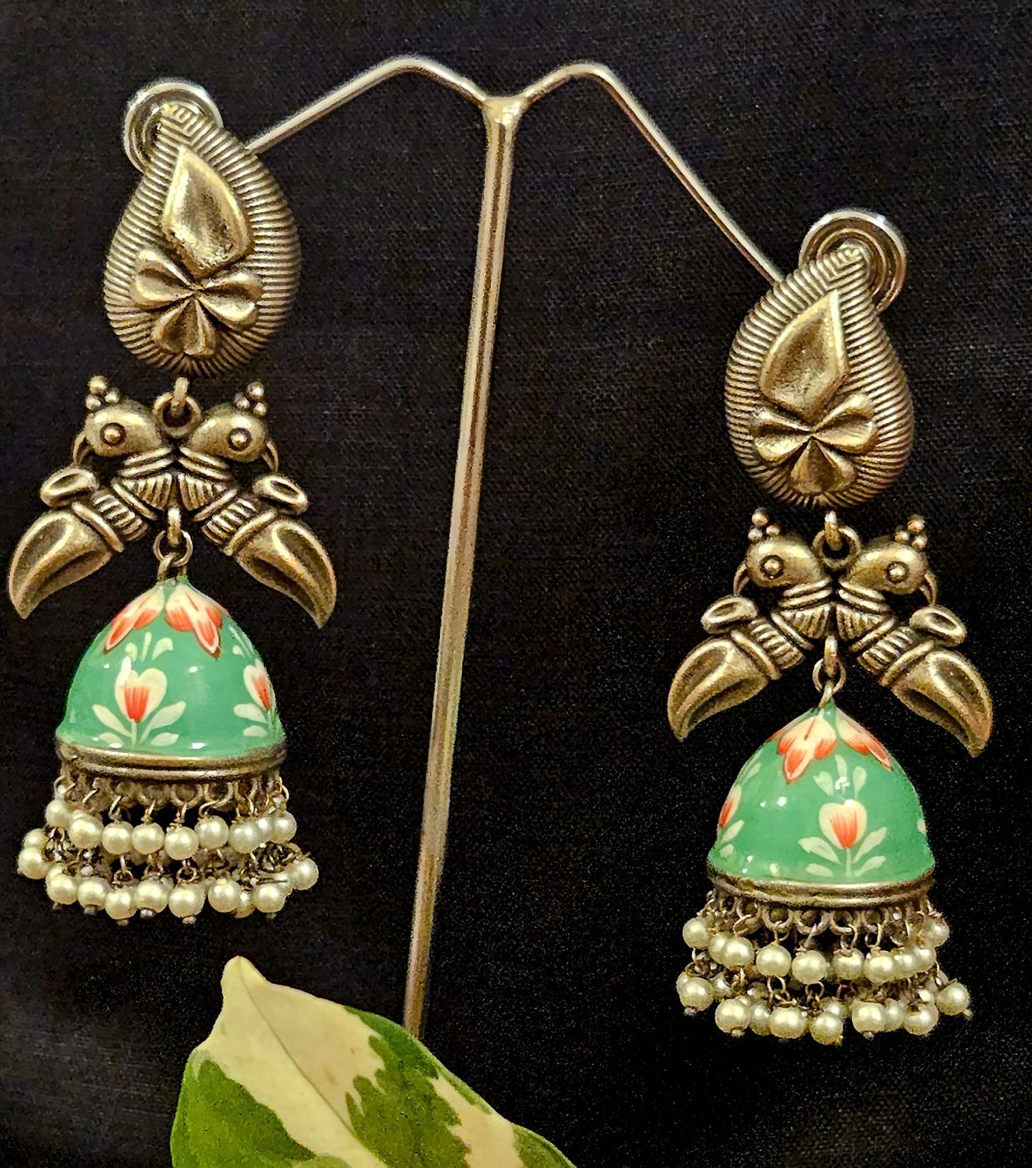 Silver finish hand painted jhumka (earrings) with paisley stud and parrot motif