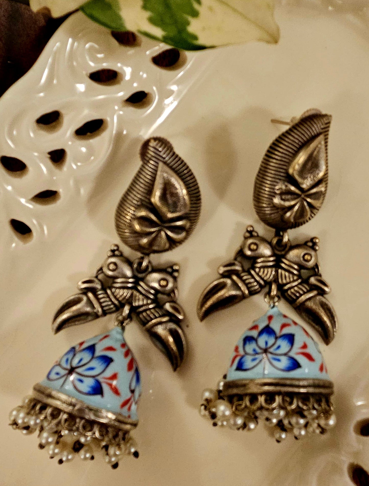 Silver finish hand painted jhumka (earrings) with paisley stud and parrot motif