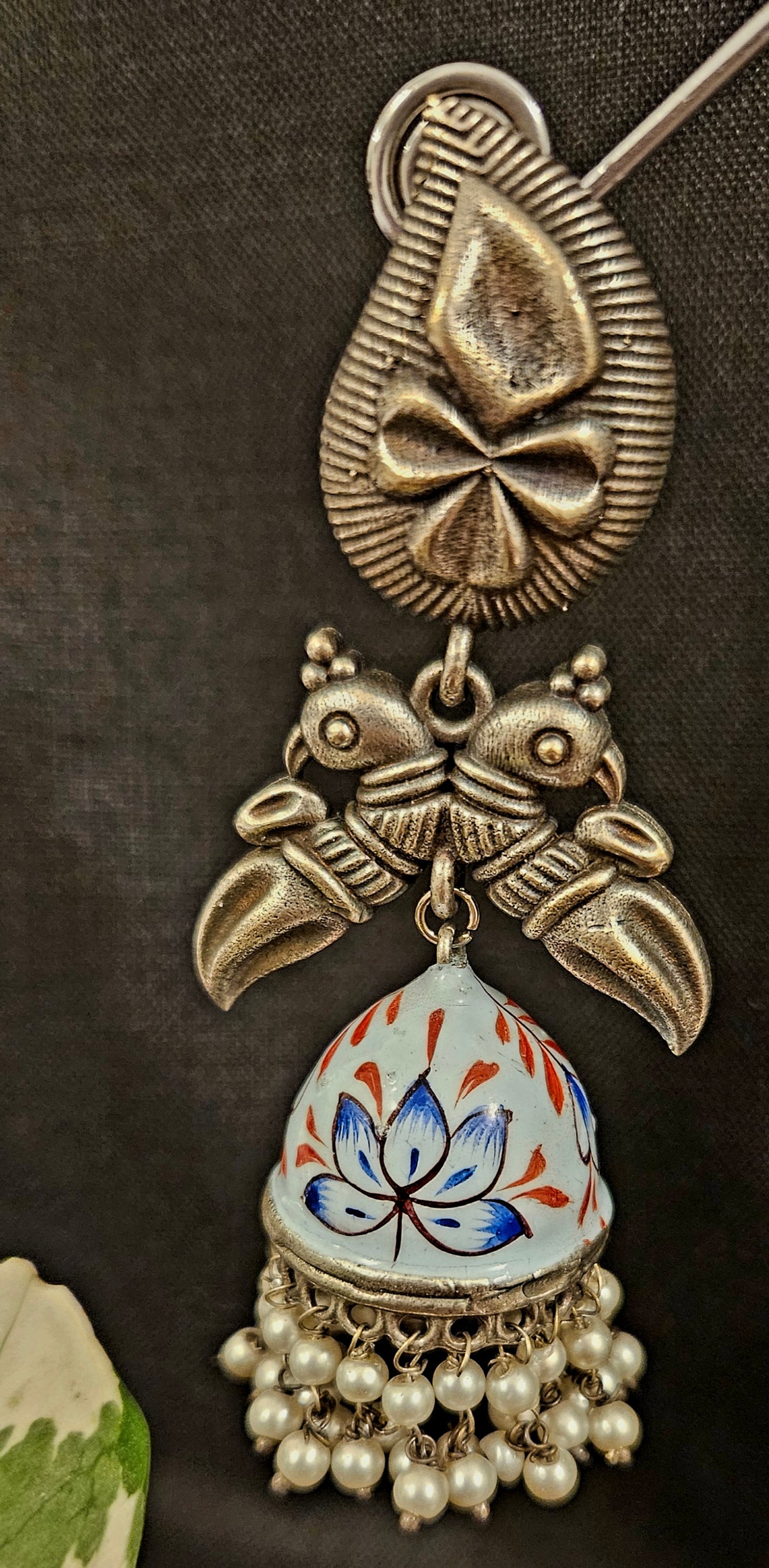 Silver finish hand painted jhumka (earrings) with paisley stud and parrot motif