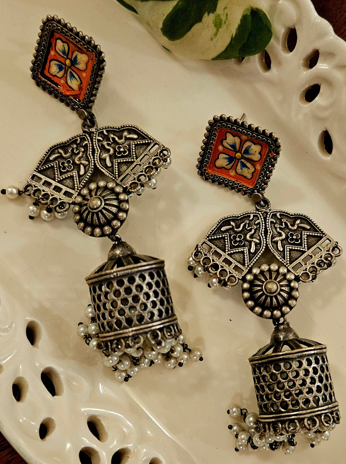 Silver finish jhumka (earrings) with hand painted stud