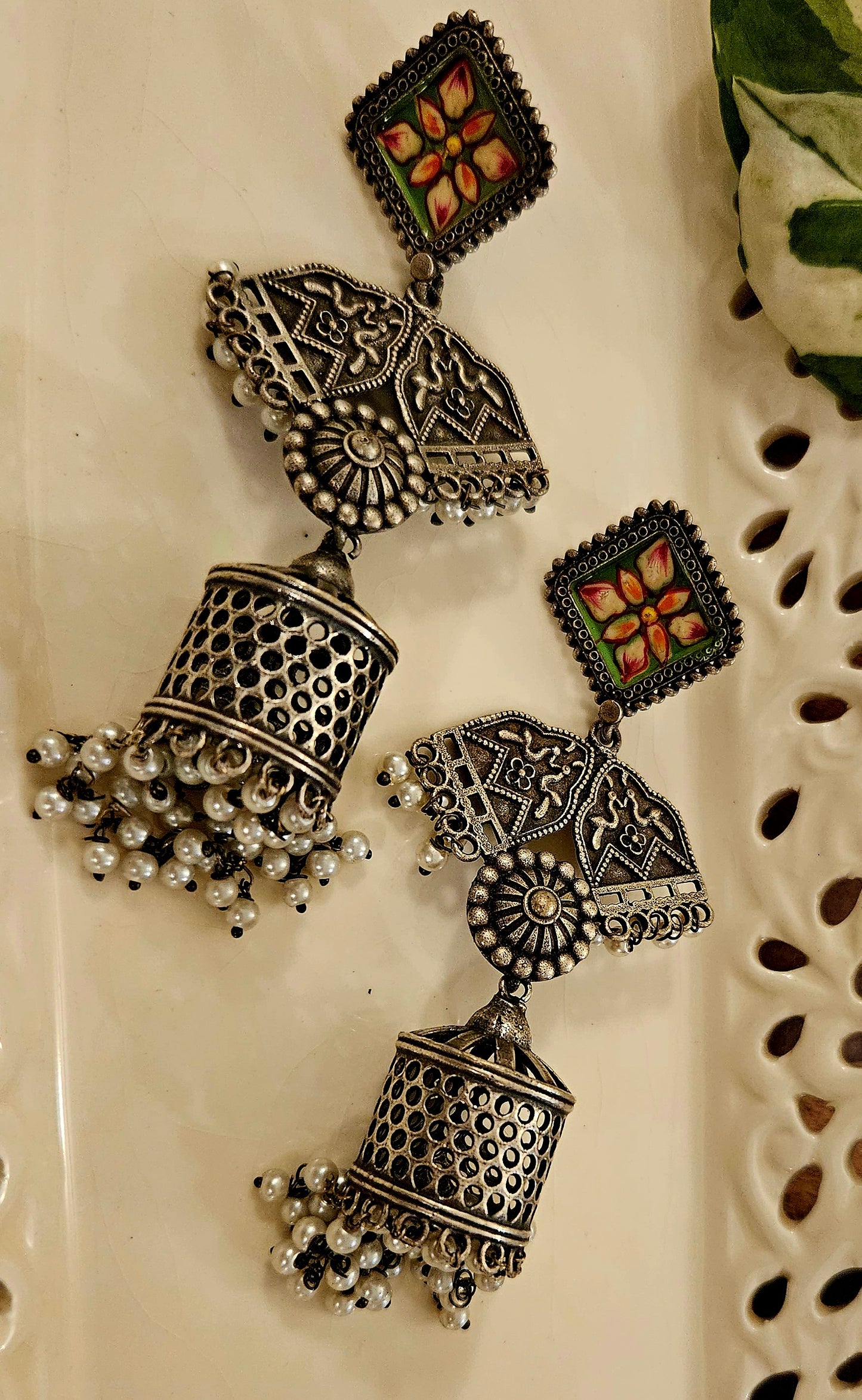 Silver finish jhumka (earrings) with hand painted stud