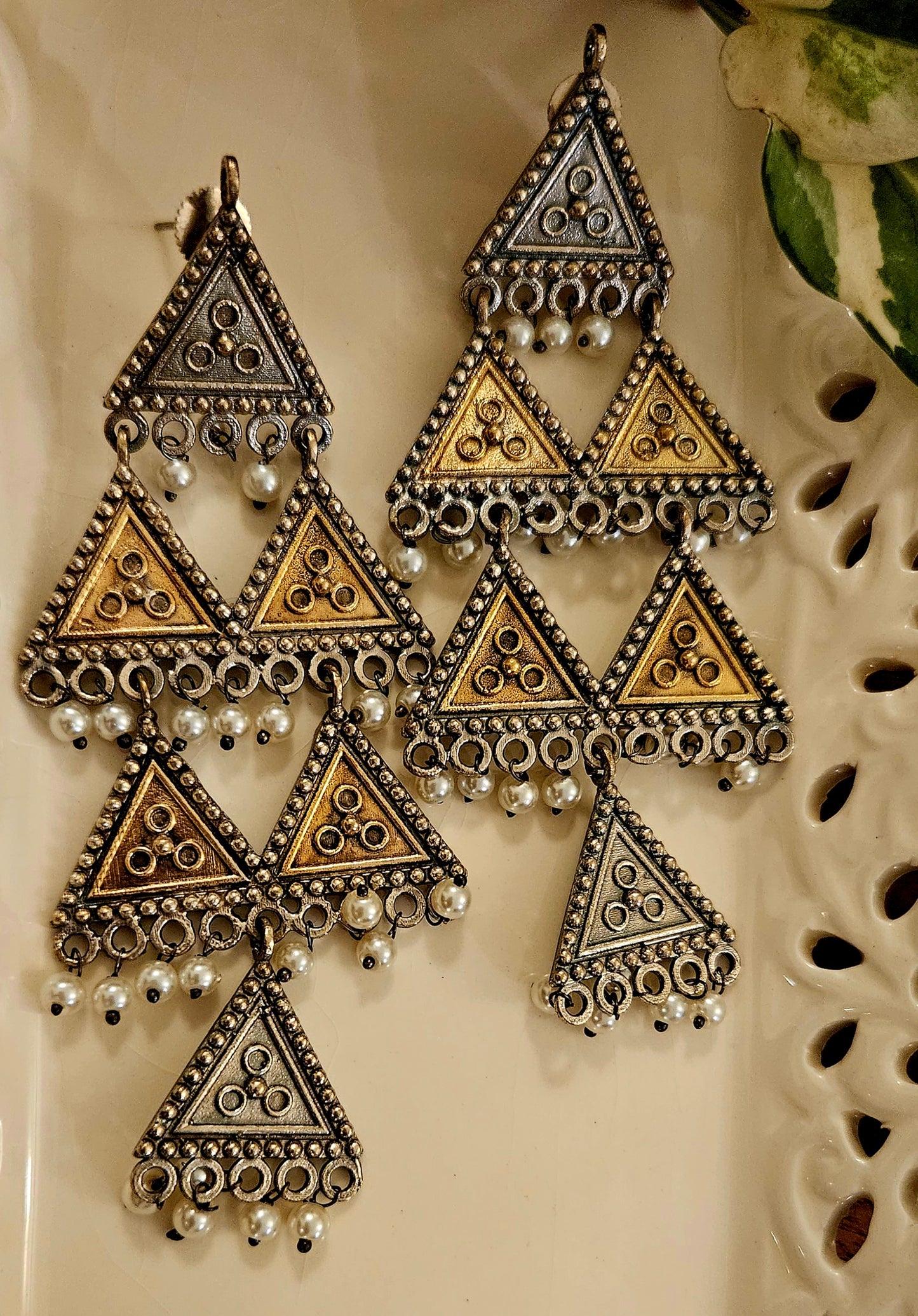 Dual tone earrings with metal triangular pieces with pearl beads