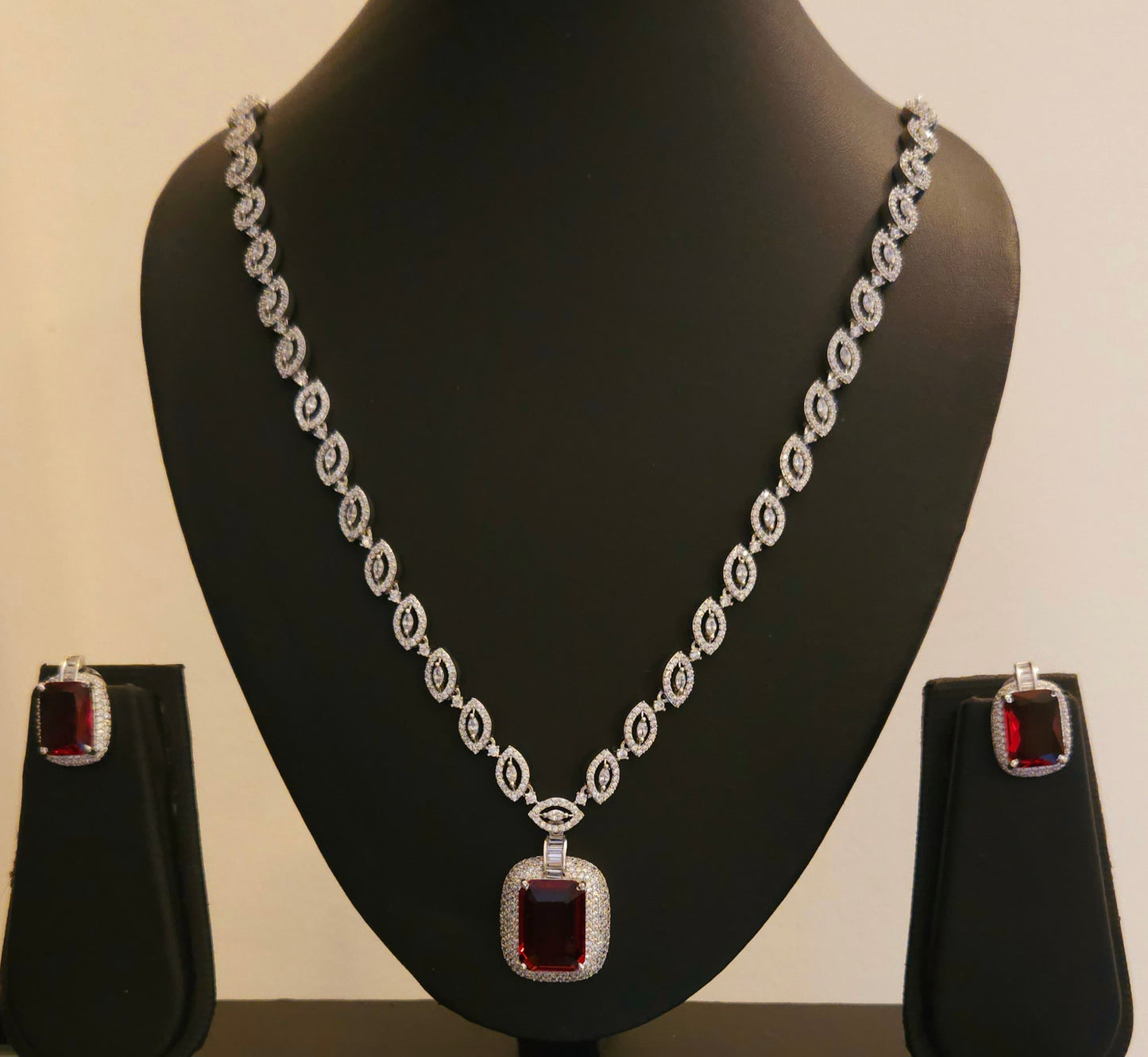 Platinum finish set with ruby pendant in CZ necklace, matching earrings