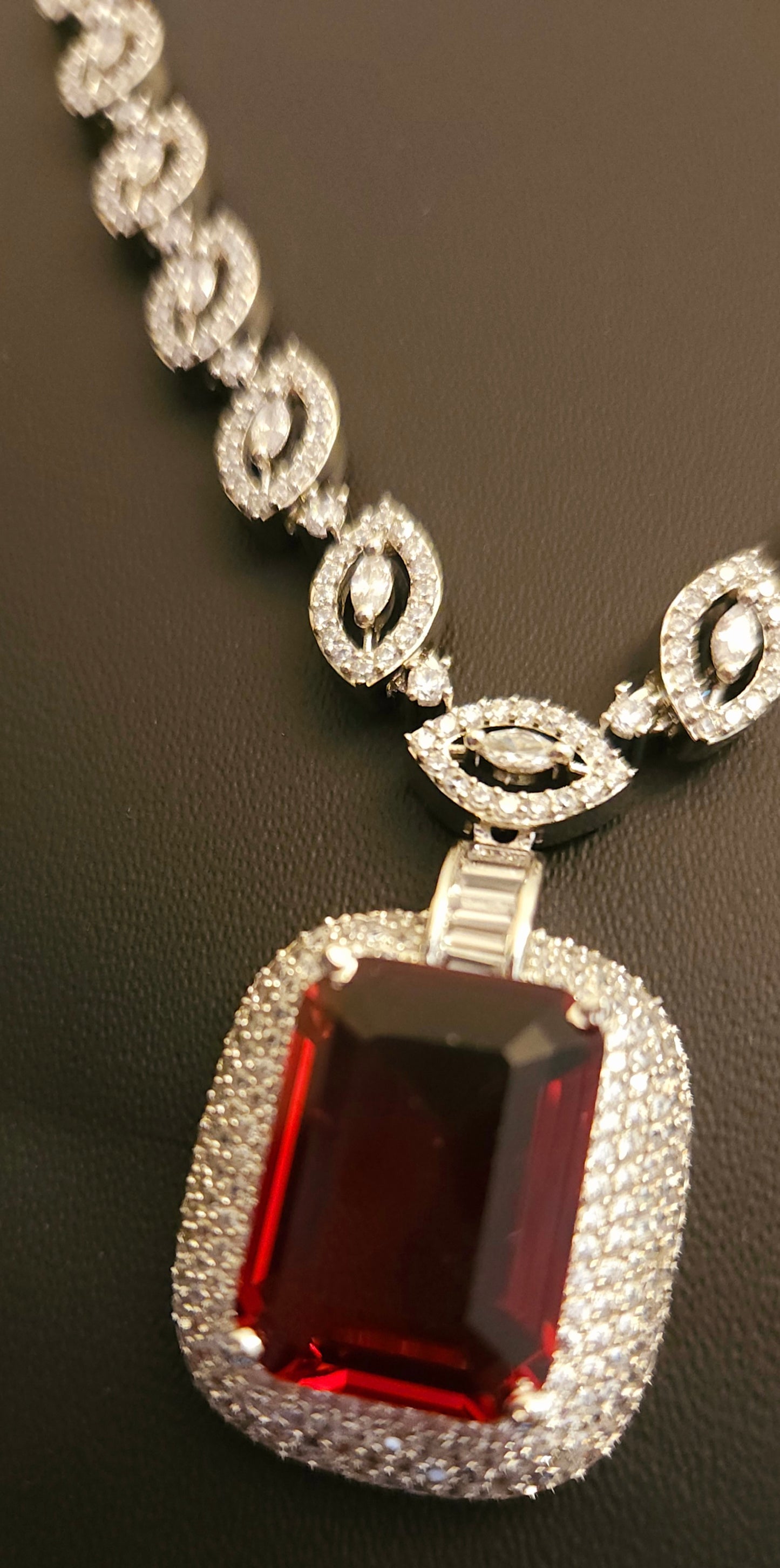 Platinum finish set with ruby pendant in CZ necklace, matching earrings