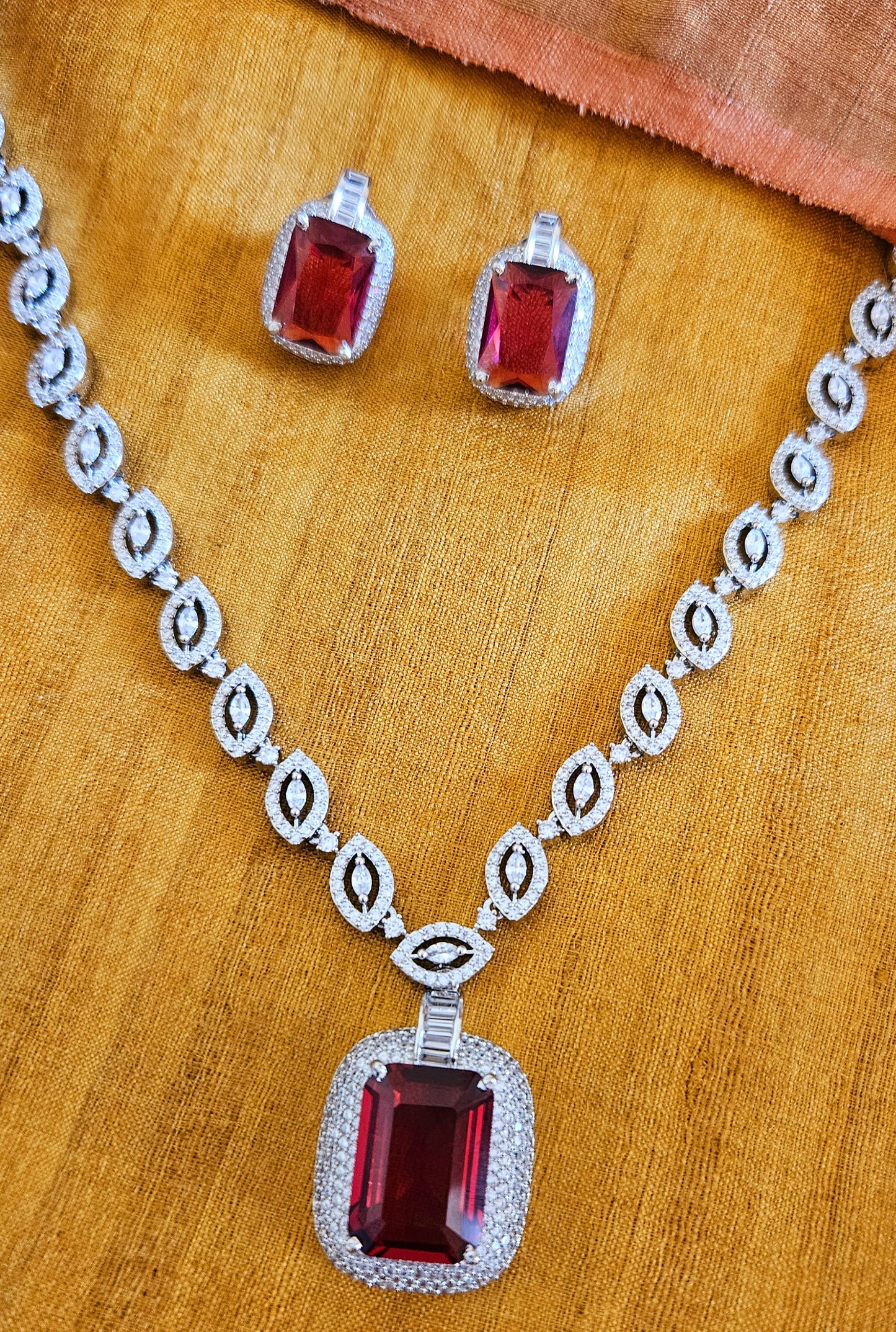 Platinum finish set with ruby pendant in CZ necklace, matching earrings