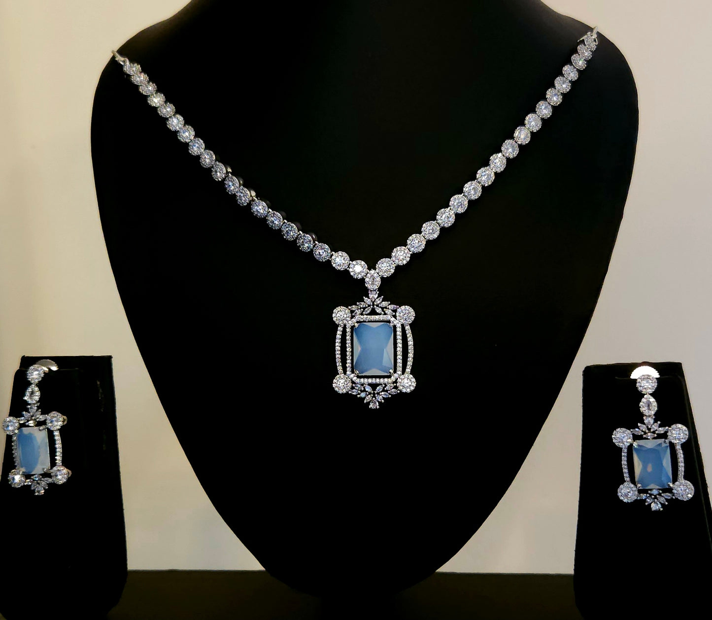 Platinum finish set with Milky white rectangular doublet pendant in CZ frame, matching earrings