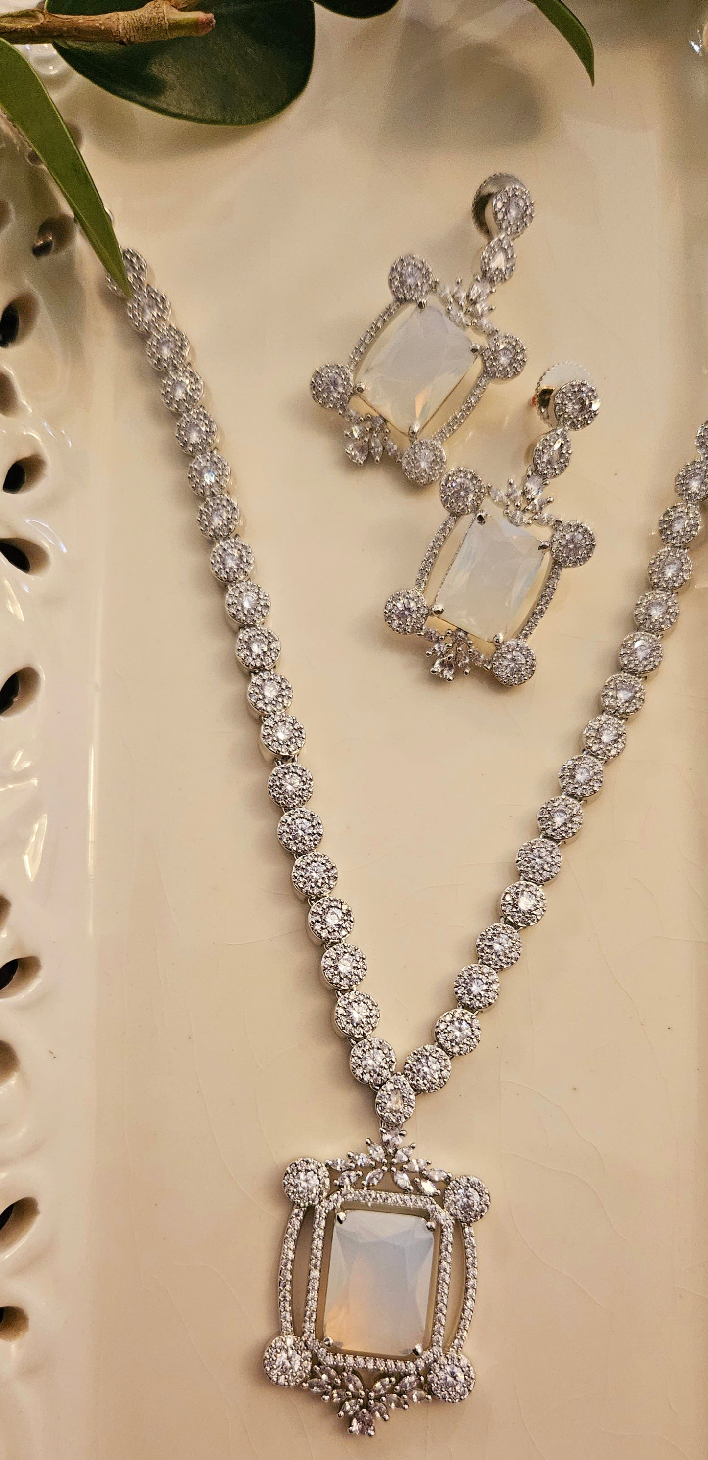 Platinum finish set with Milky white rectangular doublet pendant in CZ frame, matching earrings