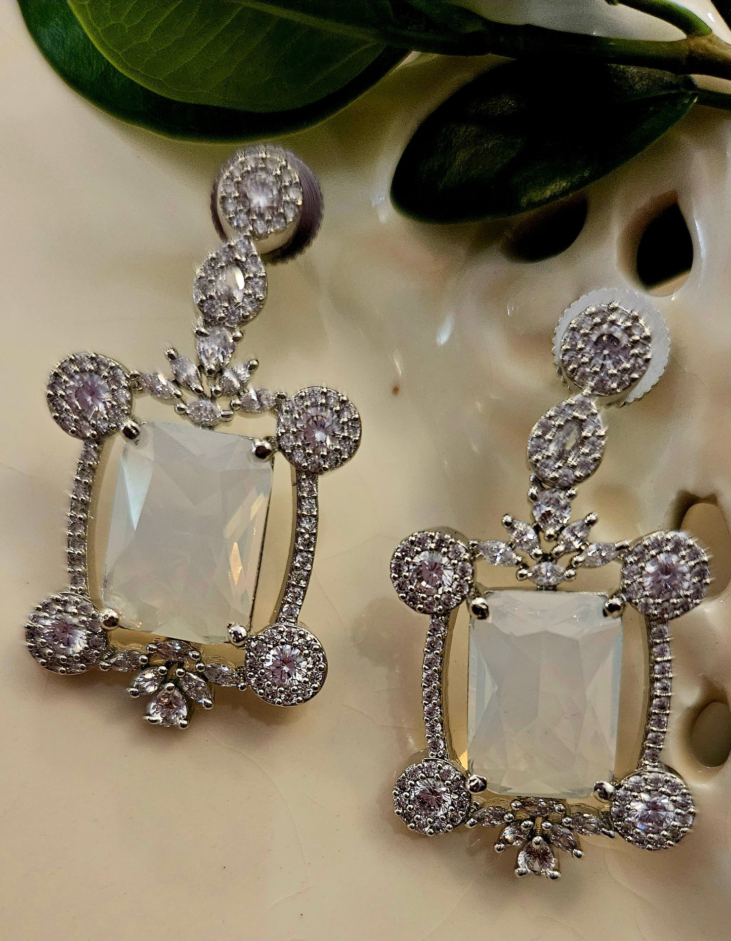 Platinum finish set with Milky white rectangular doublet pendant in CZ frame, matching earrings