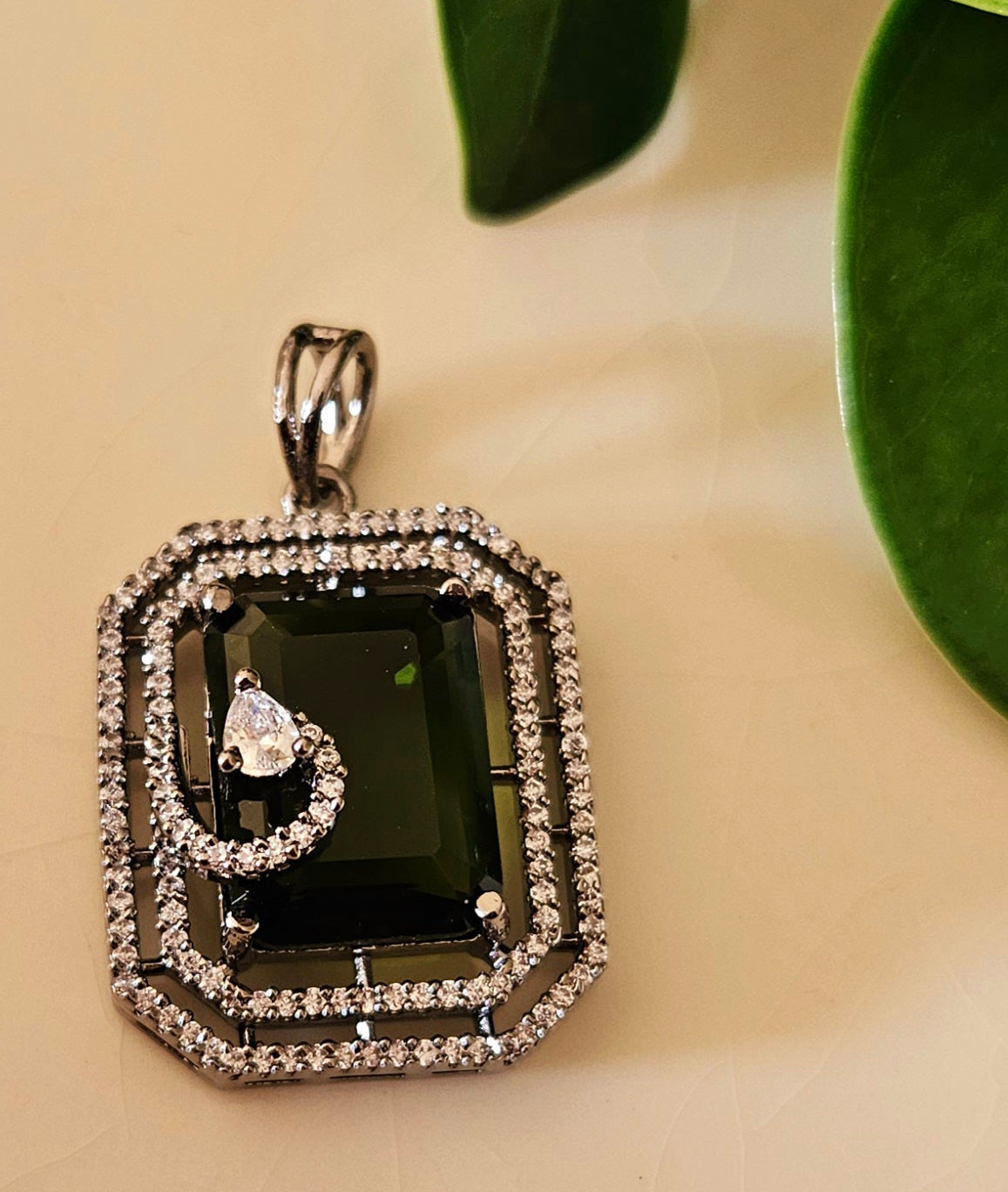 Platinum finish pendant set in topaz/green/moss green stone accentuated with CZ, matching studs (earrings)