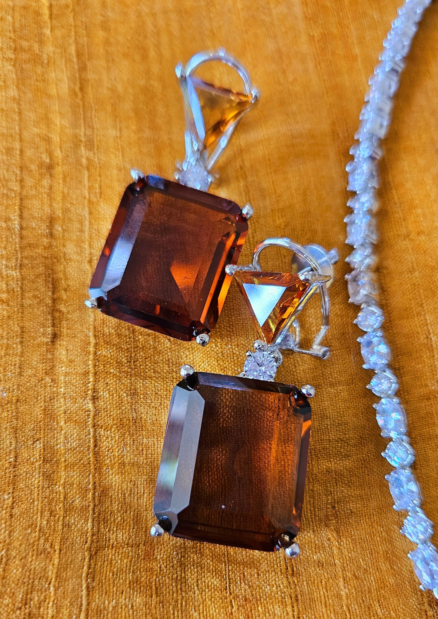 Platinum finish pedant set with topaz/brown stone pendant in CZ string, matching earrings