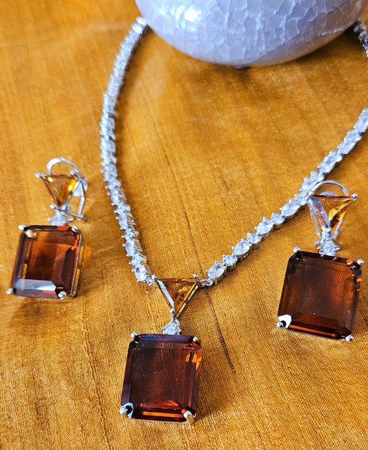 Platinum finish pedant set with topaz/brown stone pendant in CZ string, matching earrings