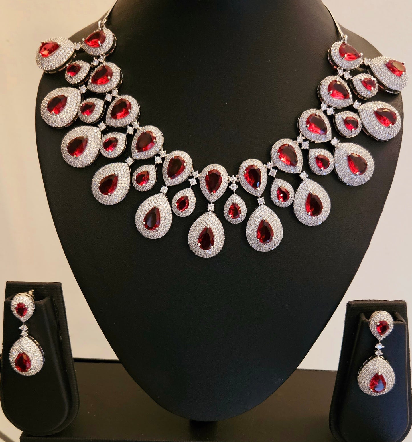 Platinum finish ruby set, teardrop themed multi-layered big necklace in ruby in CZ, matching earrings