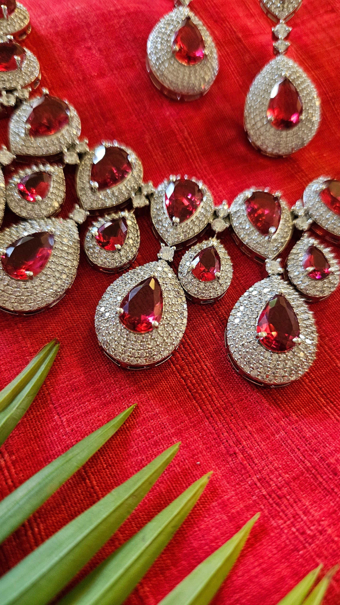 Platinum finish ruby set, teardrop themed multi-layered big necklace in ruby in CZ, matching earrings