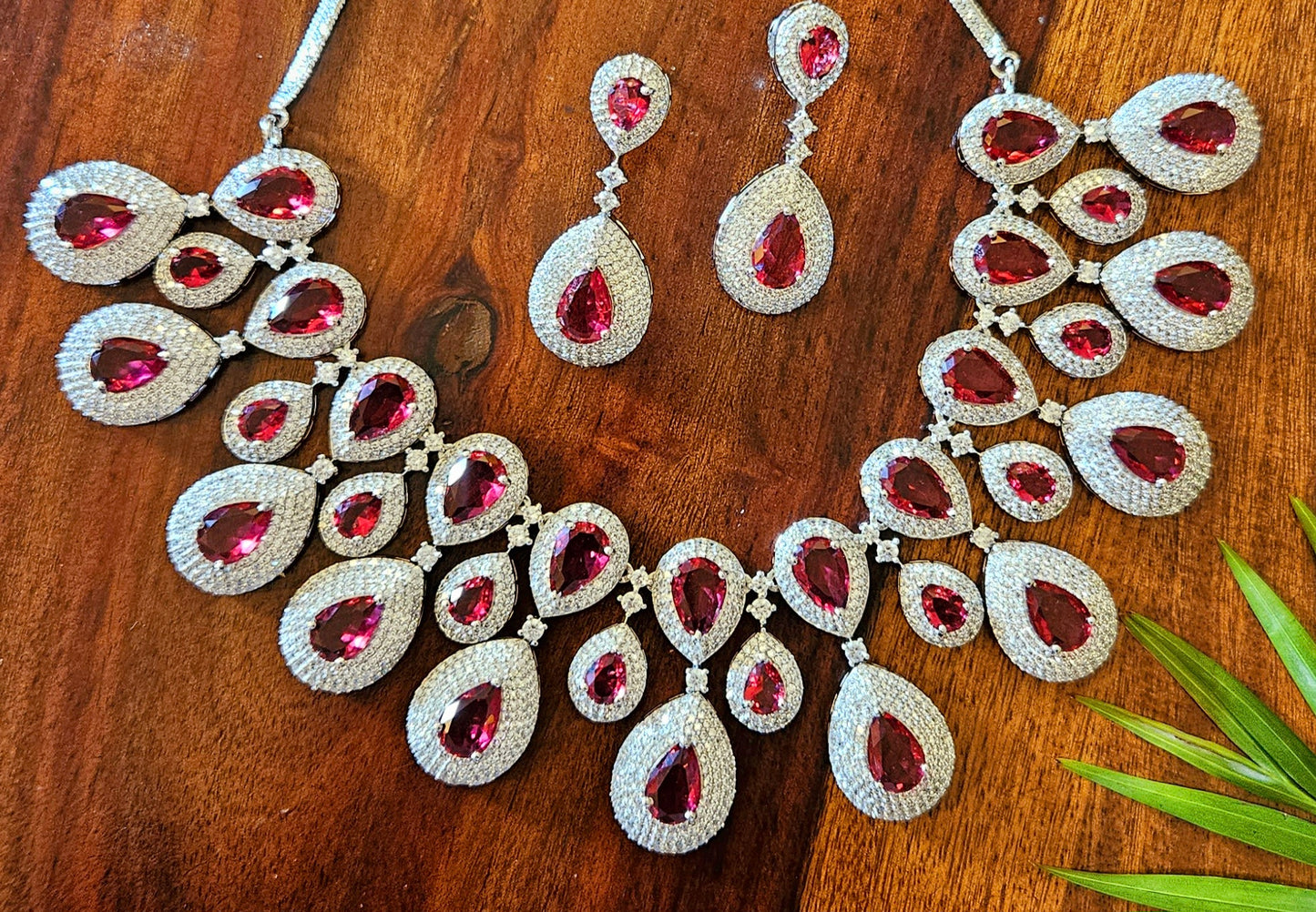 Platinum finish ruby set, teardrop themed multi-layered big necklace in ruby in CZ, matching earrings