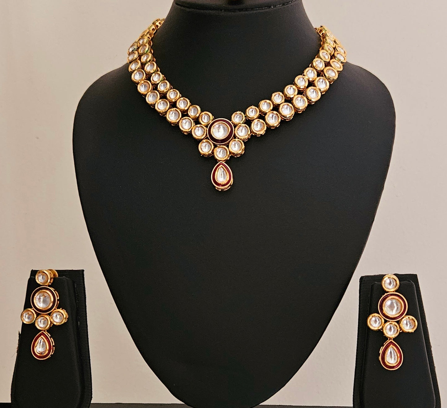 Gold finish kundan set, necklace with 2 layered kundan and red meenakari on pendant, matching maangtika and earrings