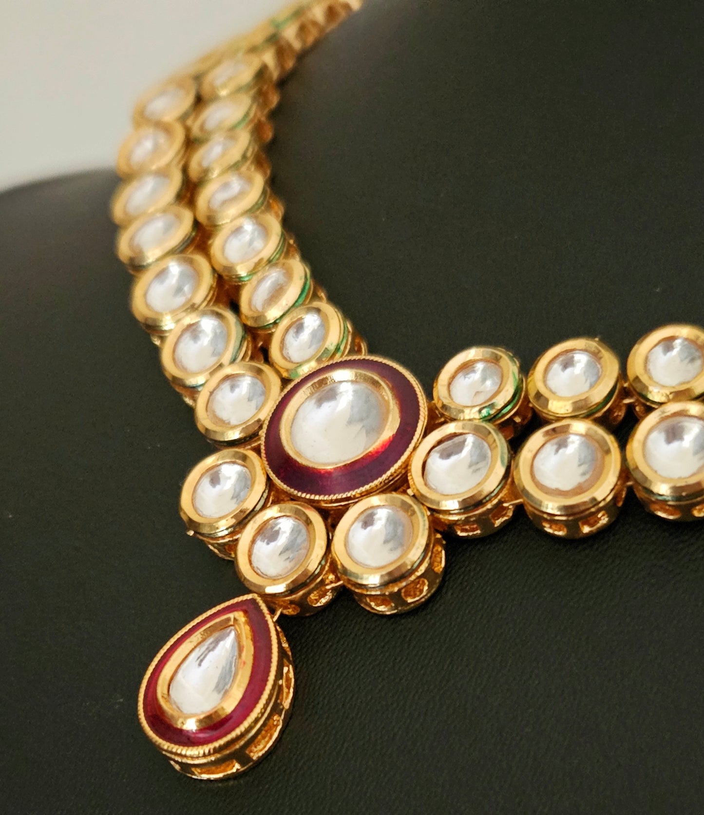 Gold finish kundan set, necklace with 2 layered kundan and red meenakari on pendant, matching maangtika and earrings