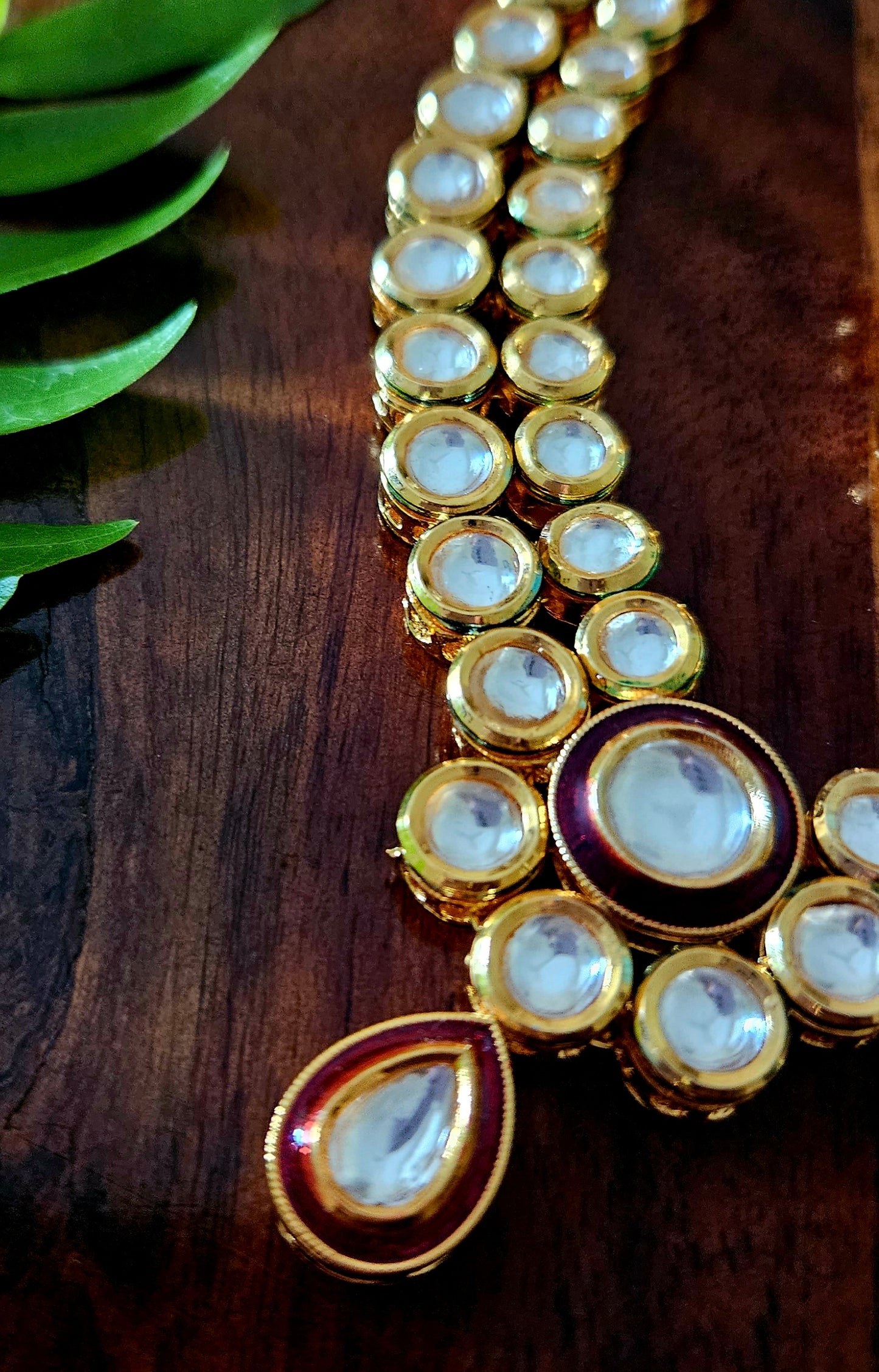 Gold finish kundan set, necklace with 2 layered kundan and red meenakari on pendant, matching maangtika and earrings