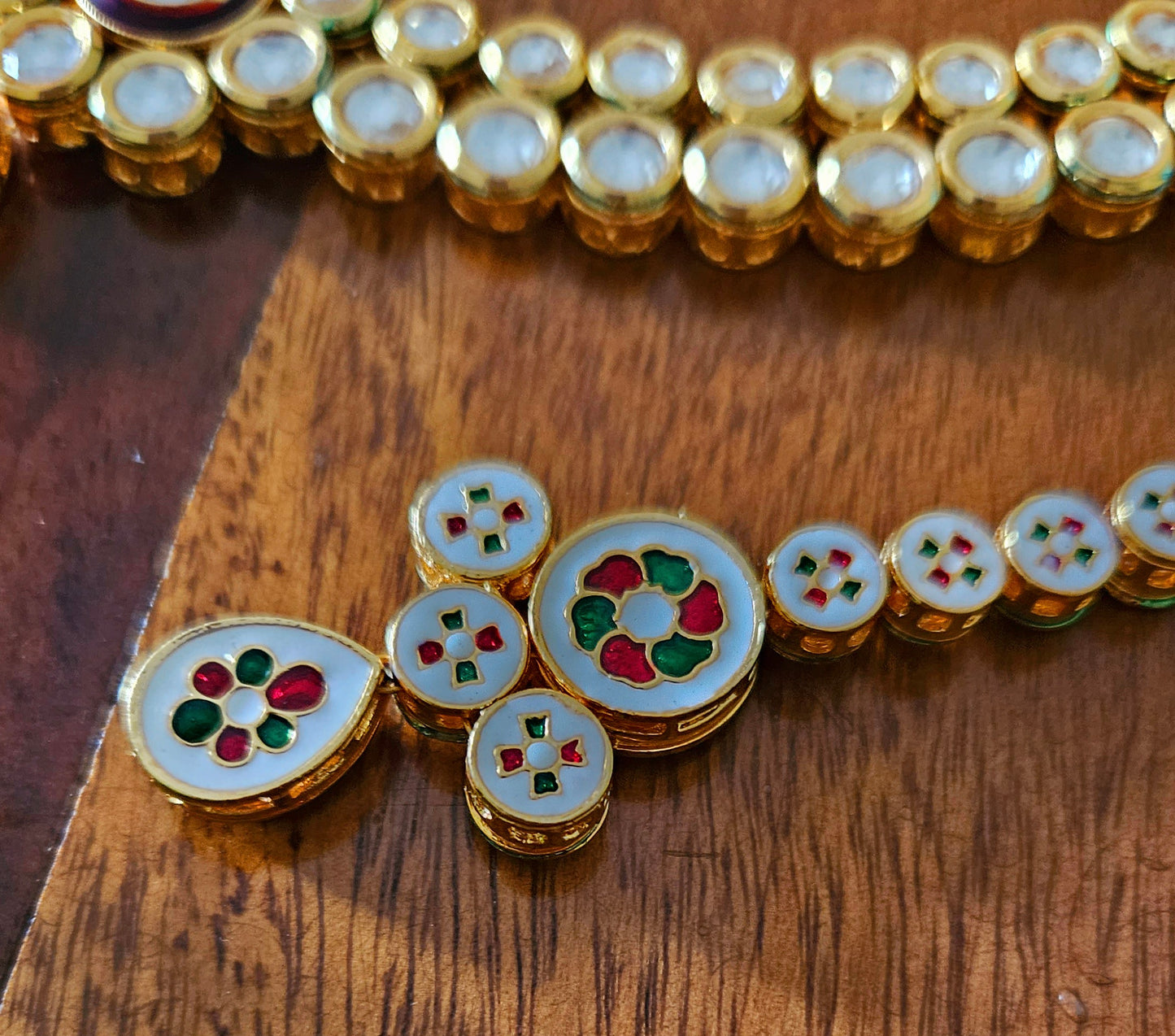 Gold finish kundan set, necklace with 2 layered kundan and red meenakari on pendant, matching maangtika and earrings