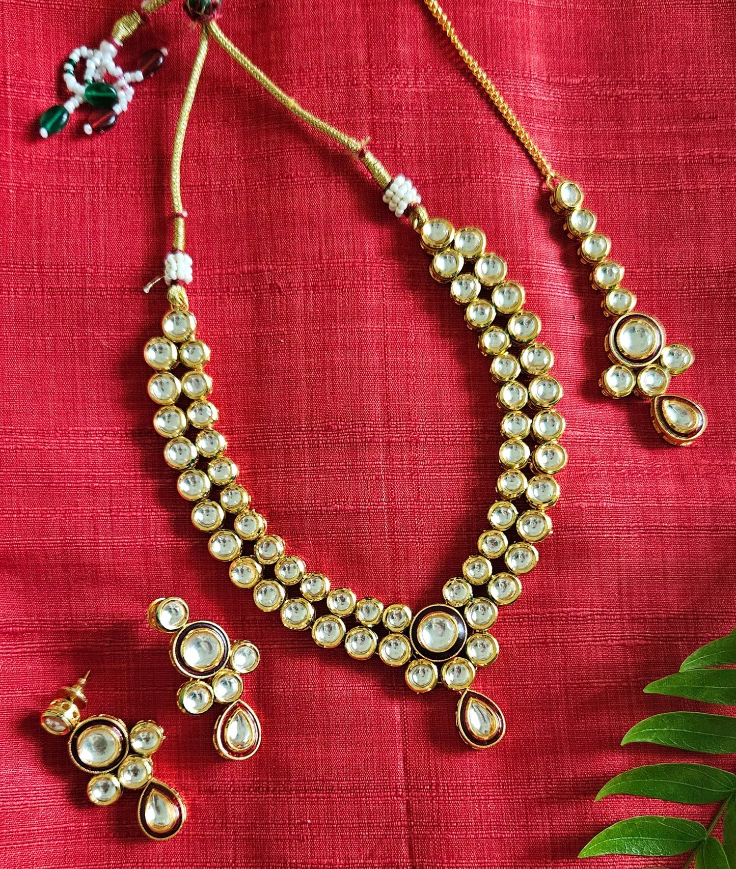 Gold finish kundan set, necklace with 2 layered kundan and red meenakari on pendant, matching maangtika and earrings