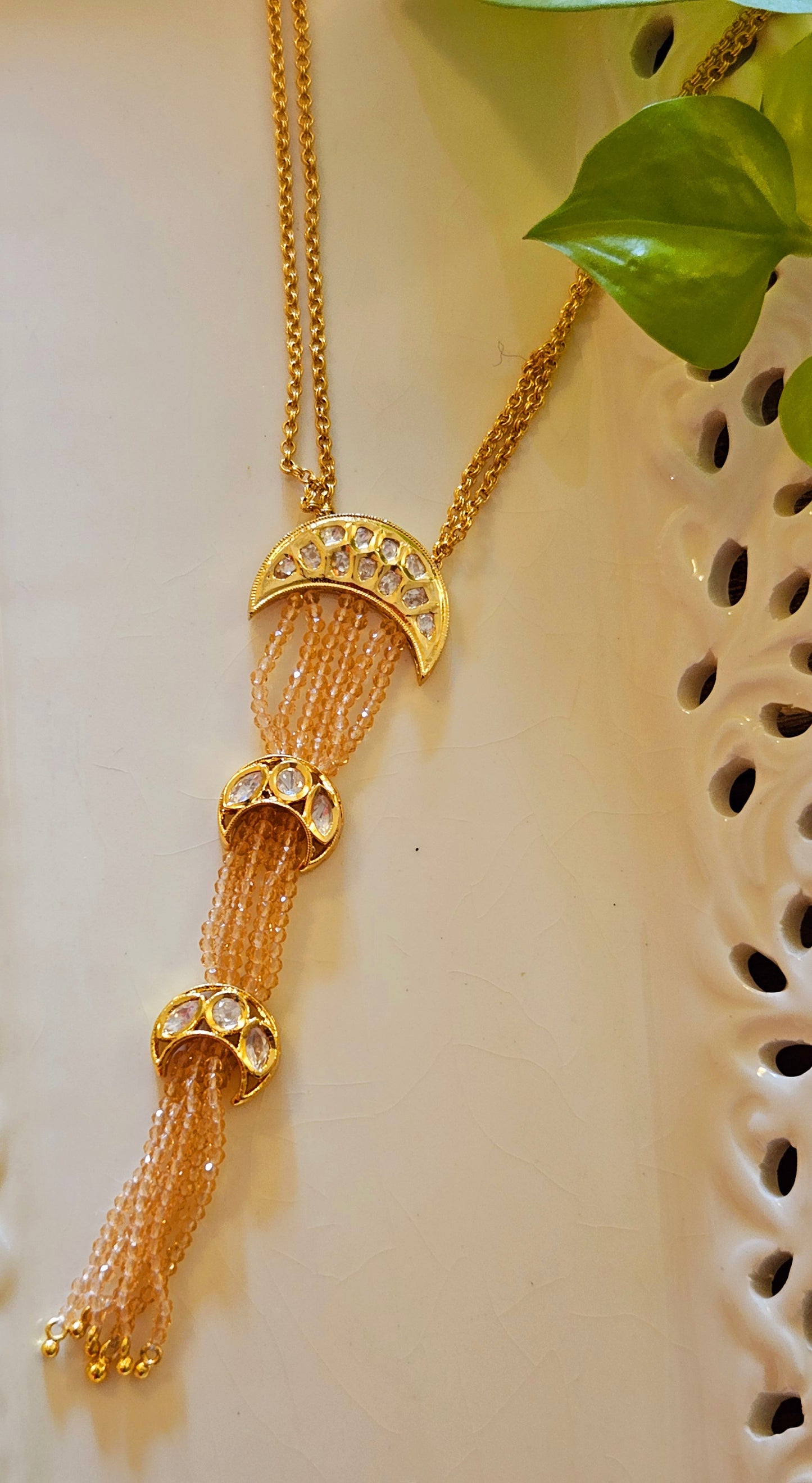 Neacklace with pale pink chain and three crescent kundan tikdas