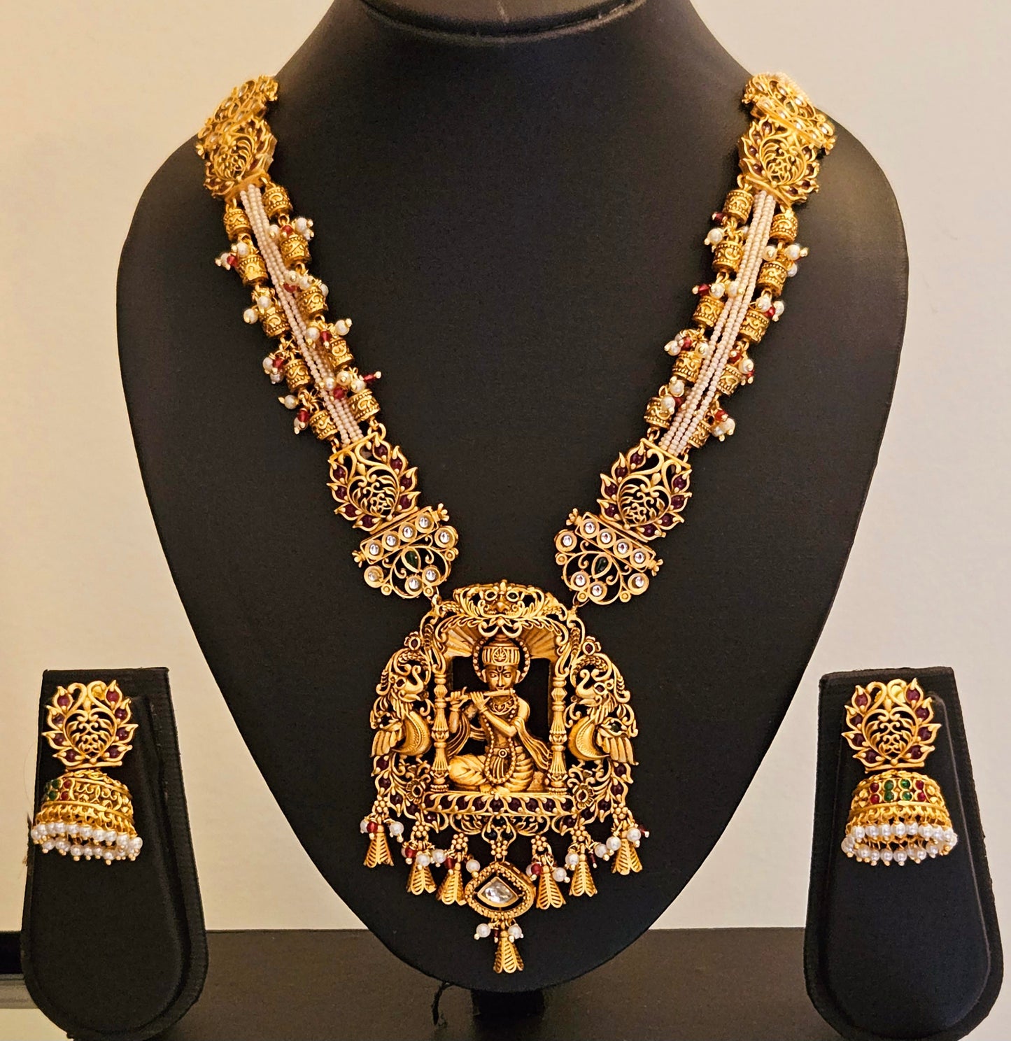 Temple jewelry set in matt gold finish necklace with krishna pendant with intricate carving, matching jhumka (earrings)