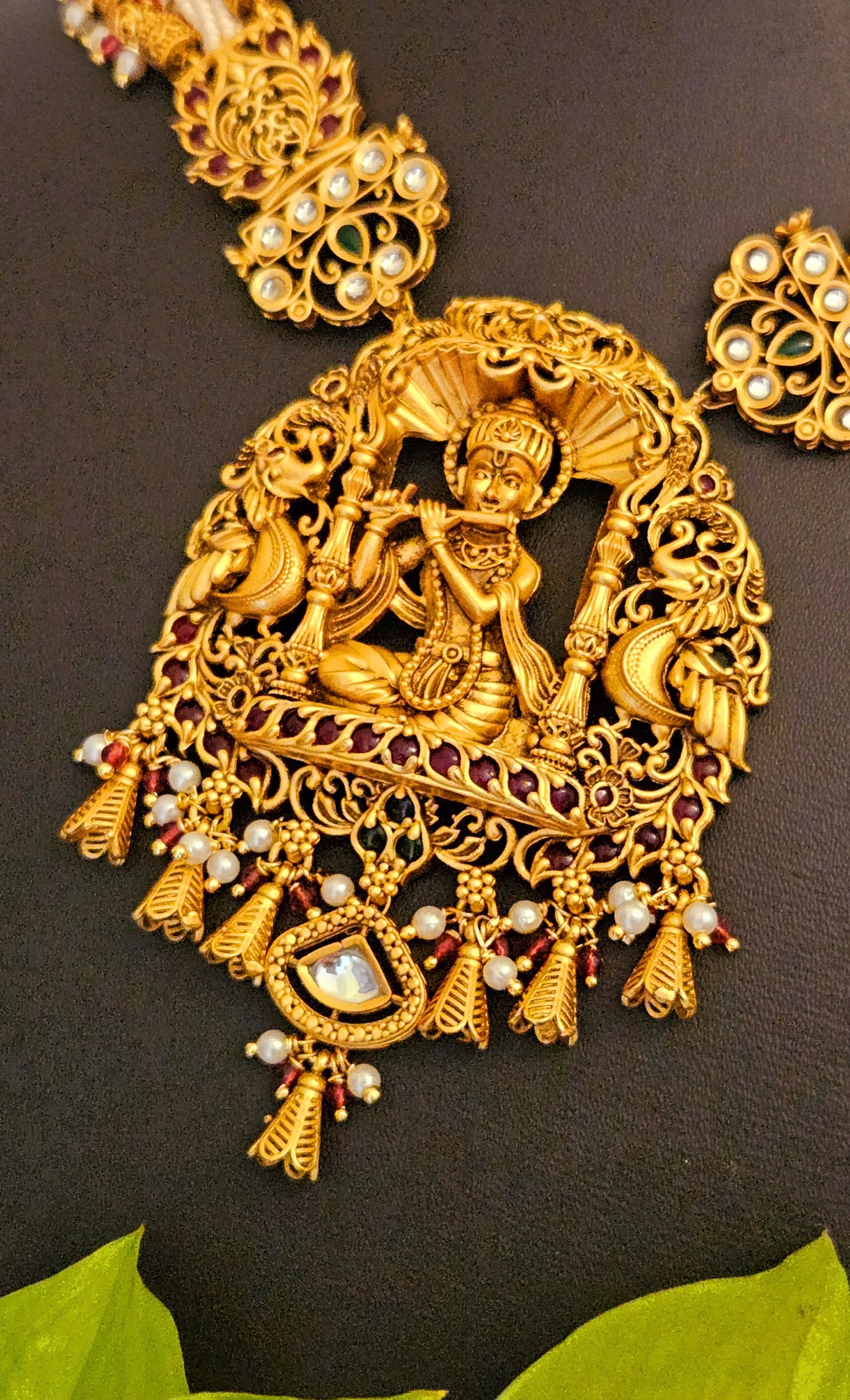 Temple jewelry set in matt gold finish necklace with krishna pendant with intricate carving, matching jhumka (earrings)