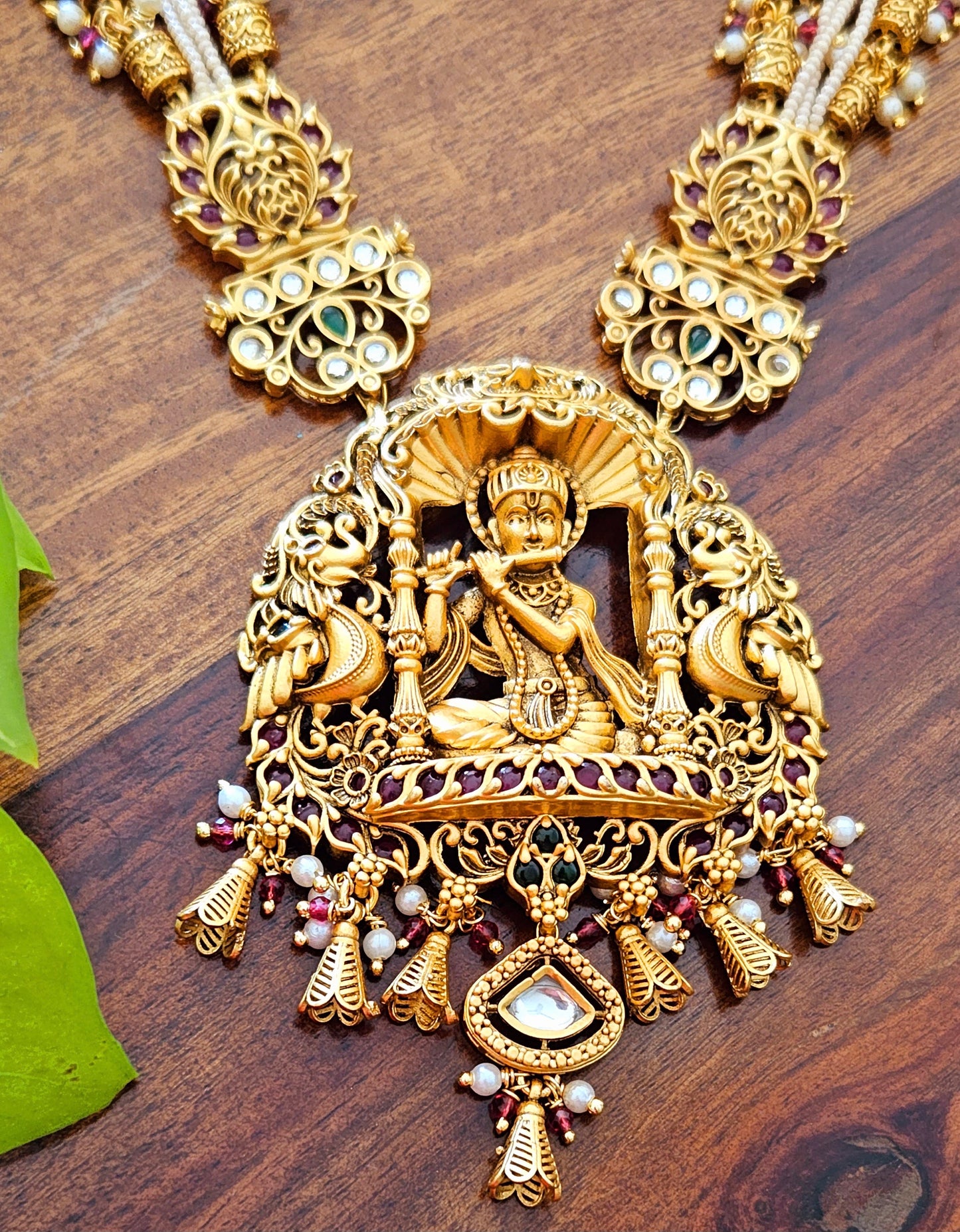 Temple jewelry set in matt gold finish necklace with krishna pendant with intricate carving, matching jhumka (earrings)