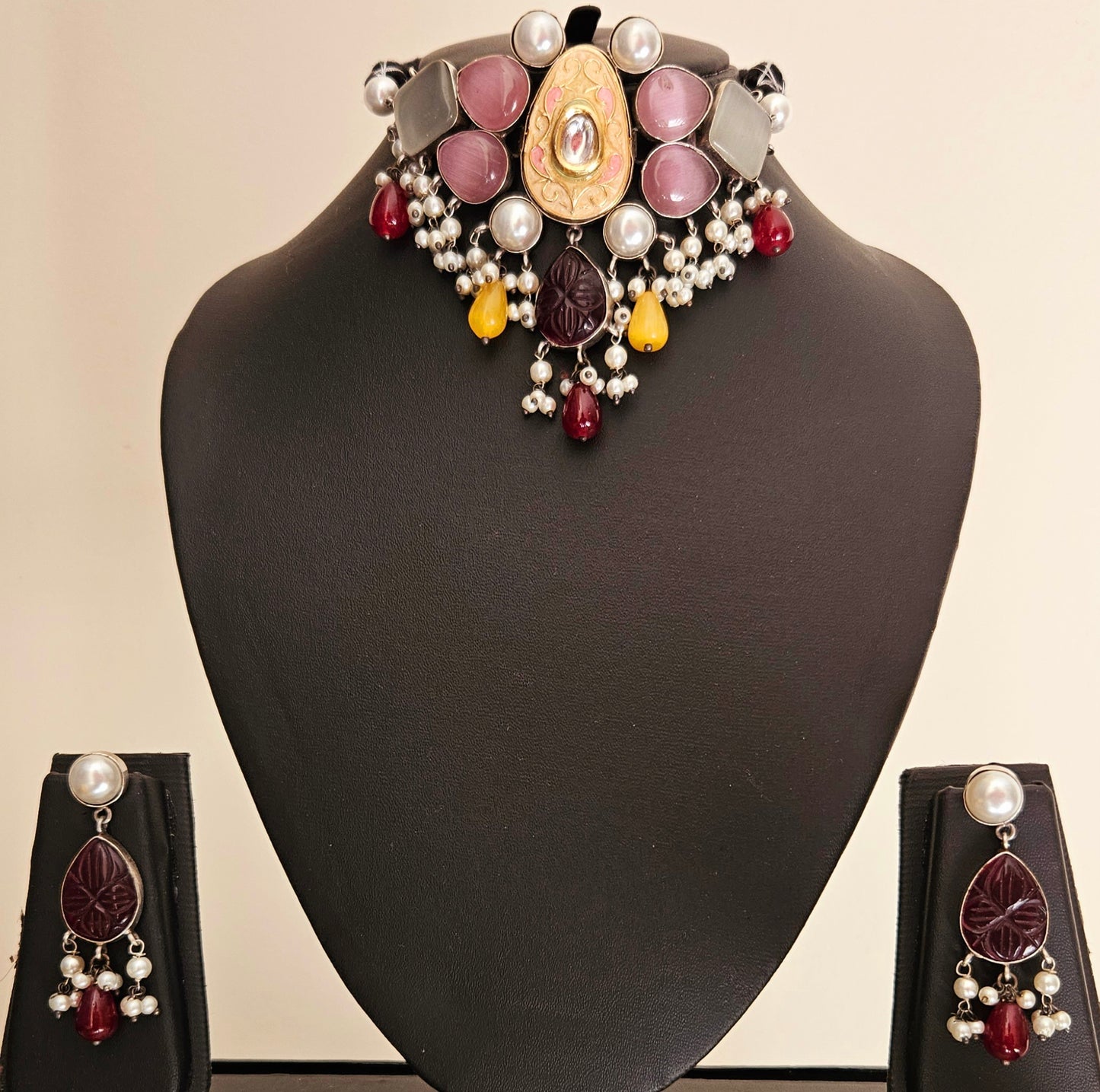 Choker set with multiple sized pale pink and mint stones set around peach meenakari encrusted with kundan central piece, matching earrings