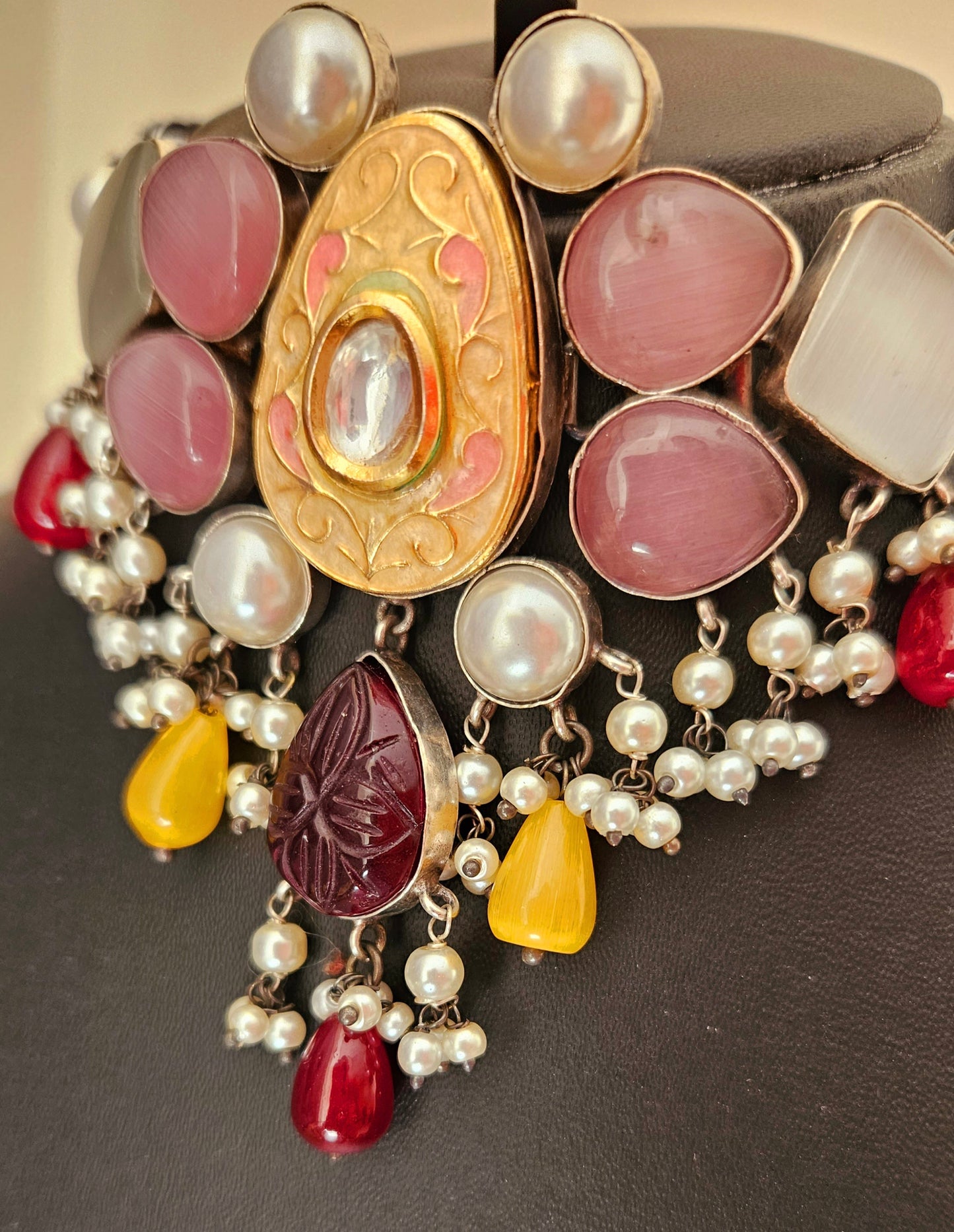 Choker set with multiple sized pale pink and mint stones set around peach meenakari encrusted with kundan central piece, matching earrings