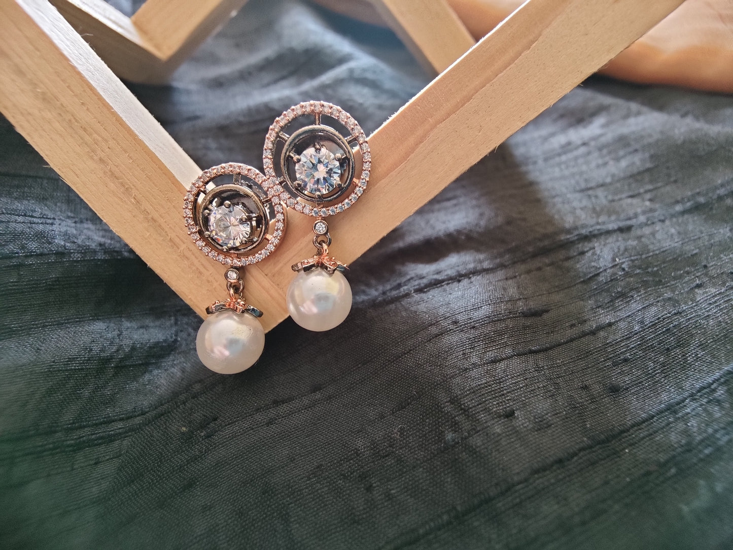 Dangling pearl and CZ stone earrings