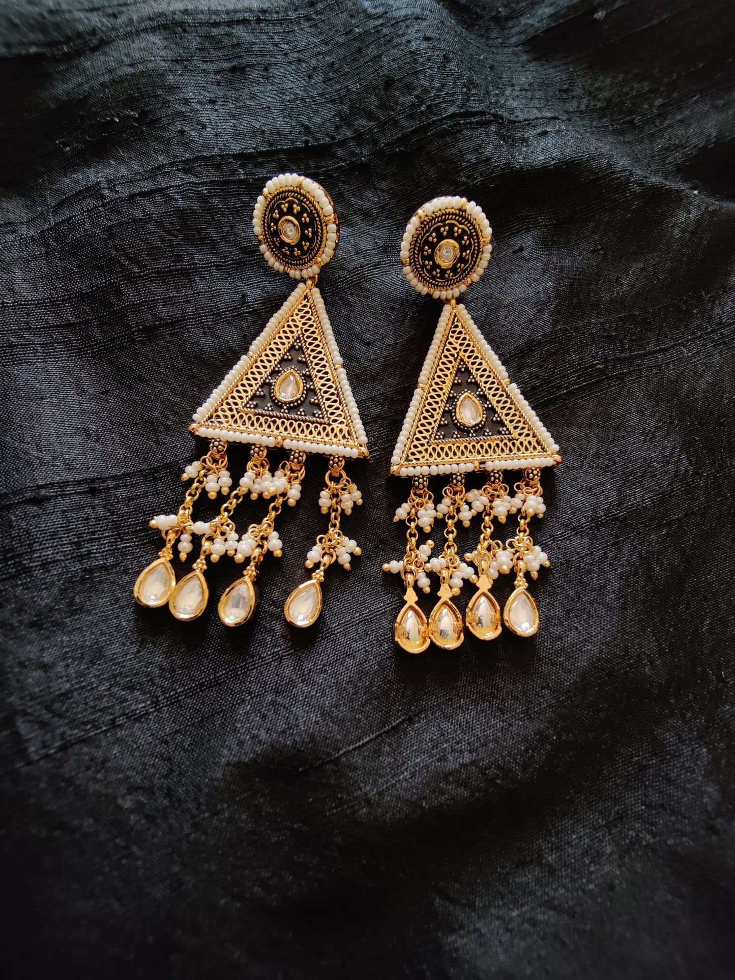 Intricate gold finish necklace and dangling earrings with black enamel, kundan and delicate miniature pearls