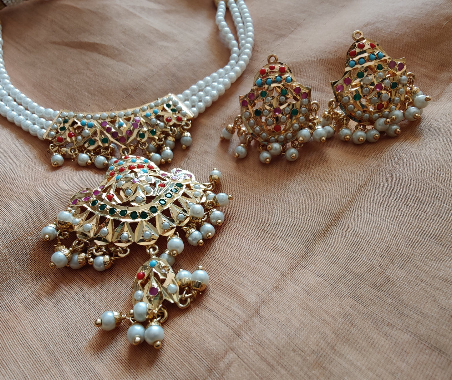 'Navratan' jadau necklace in triple pearl strands and matching earrings set