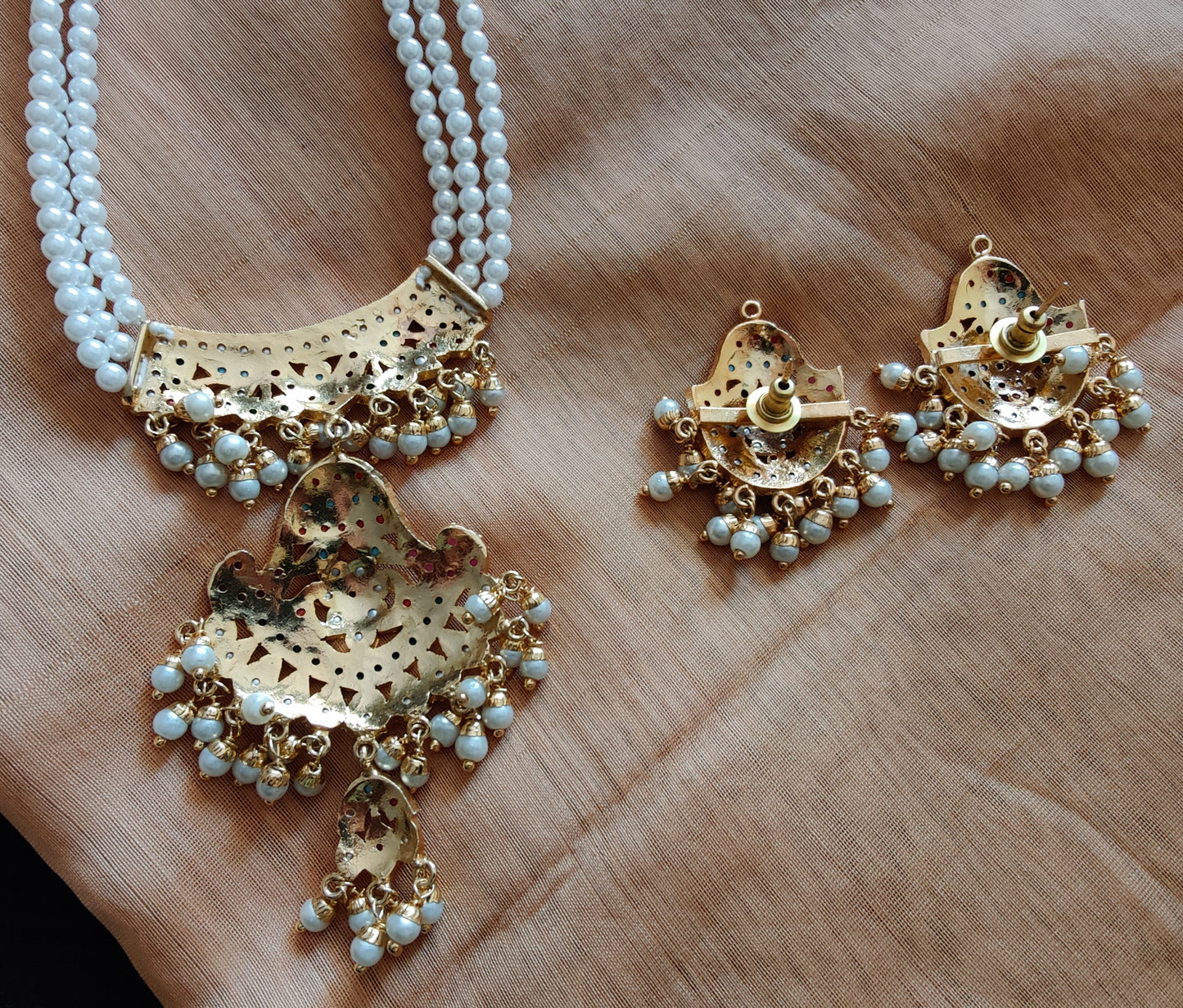 'Navratan' jadau necklace in triple pearl strands and matching earrings set