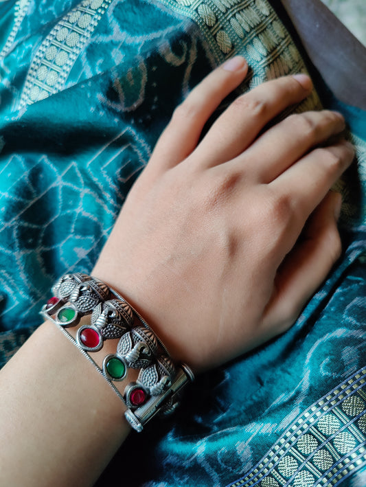 Silver finish bangle in peacock design, emerald and ruby stone work (1 pc)