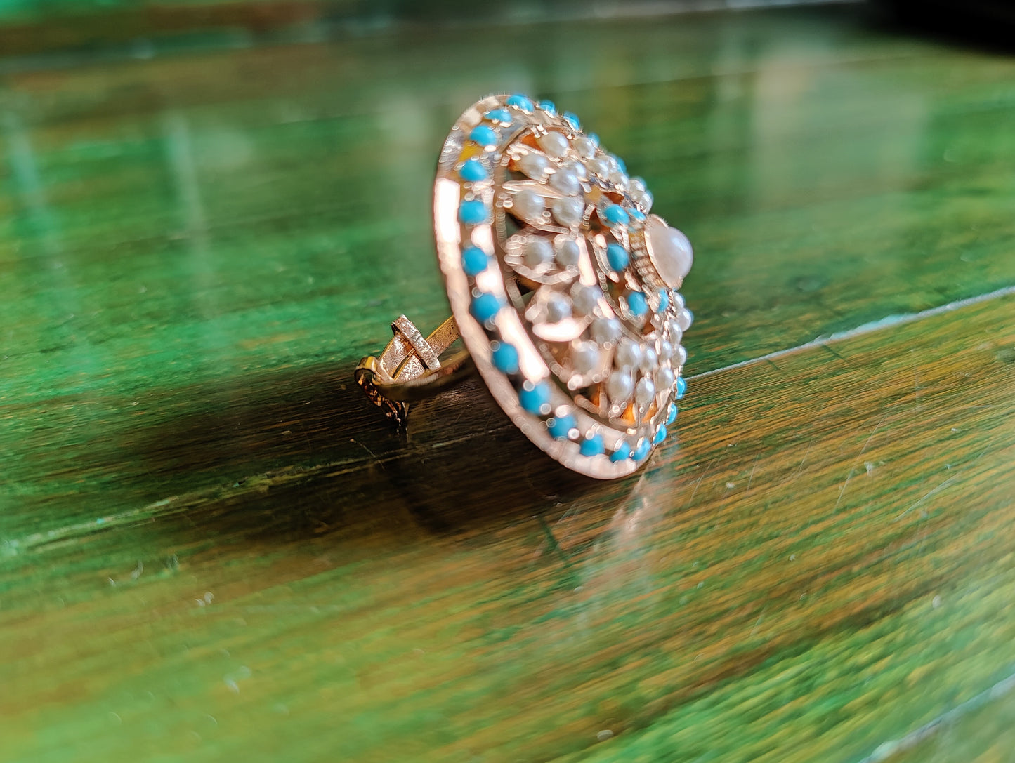 Gold finish circular jadau ring with blue/turquoise stone and pearl detailing