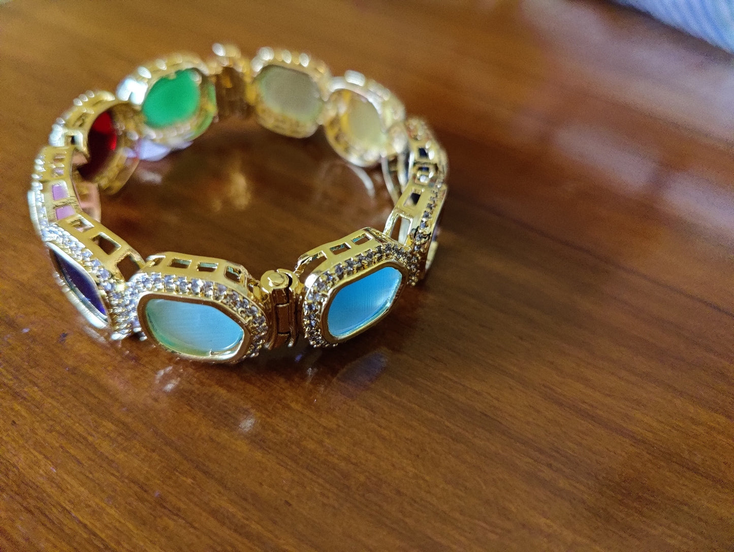 Bangle(Kara) with multicoloured big stones encircled by CZ , in gold finish (1 pc)