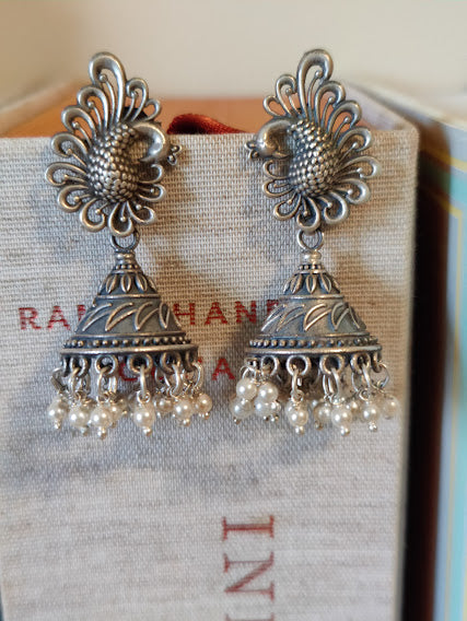 Silver peacock jhumkas (earrings) with conical dome and pearls