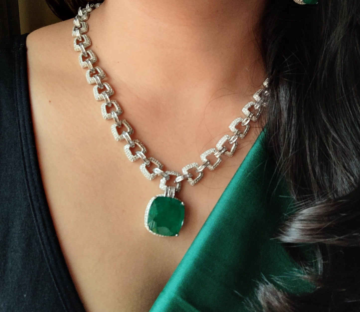 Platinum finish set, necklace in thick chain design with chunky emerald pendant, matching earrings