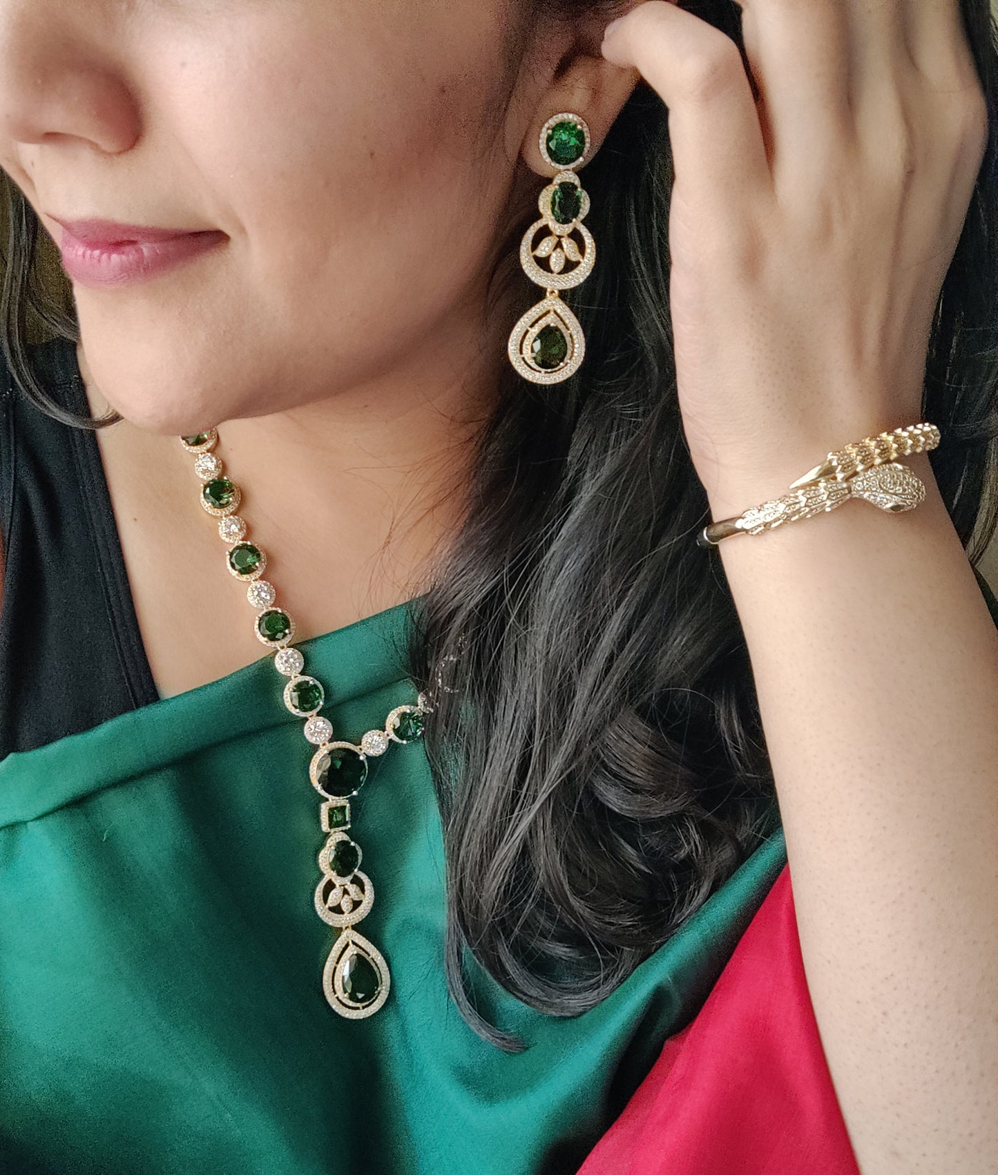 Gold finish set with long necklace in round CZ and emerald pieces, matching earrings