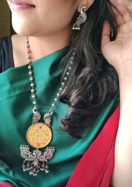 Silver finish hand-painted set with big yellow pendant and peacock motif , matching earrings