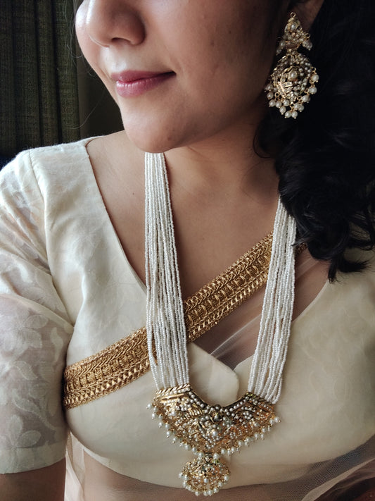 'Virtuous white' gold finish jadau set with navratan/pearl inlaid long necklace and matching earrings