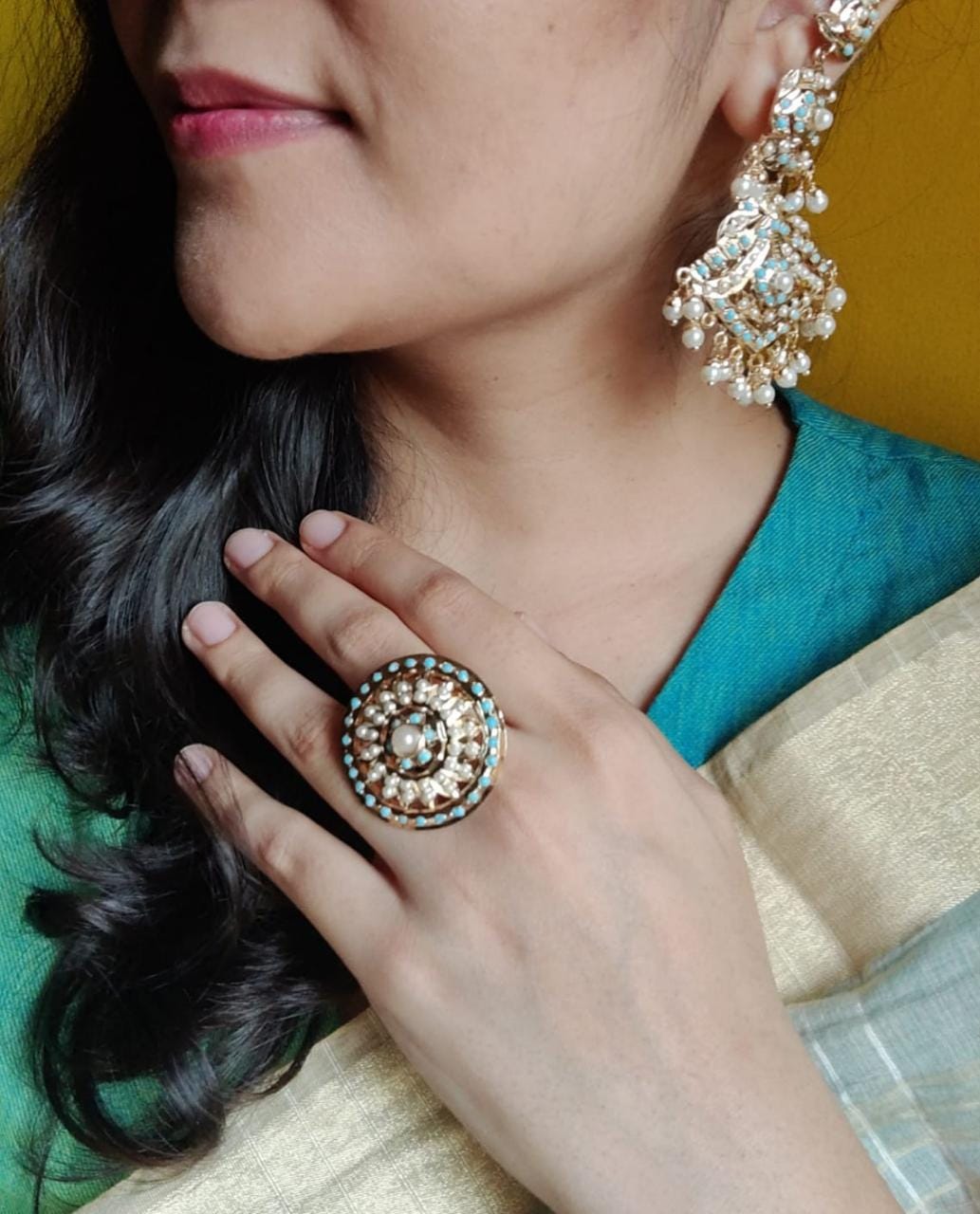 Jadau earrings with turquoise stone and pearl inlay