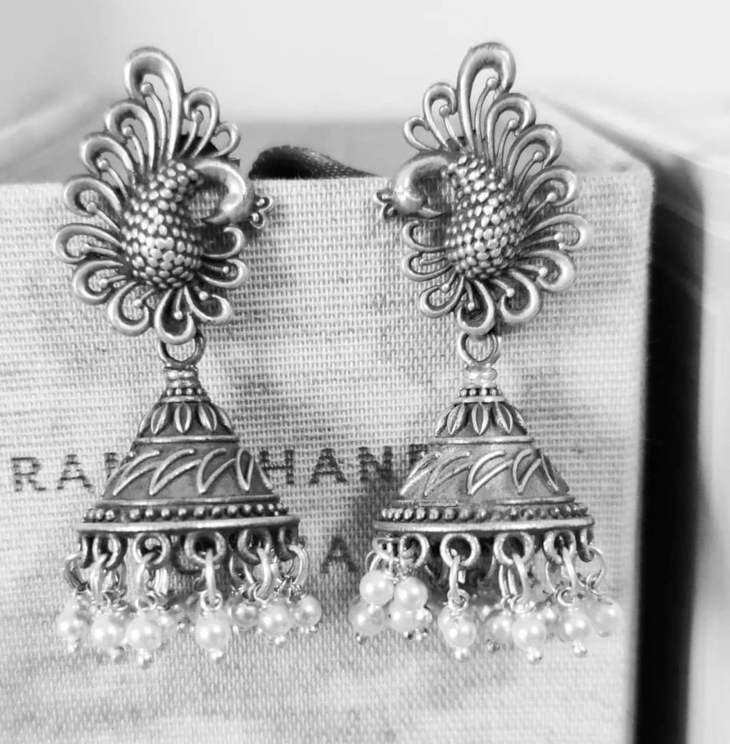 Silver peacock jhumkas (earrings) with conical dome and pearls